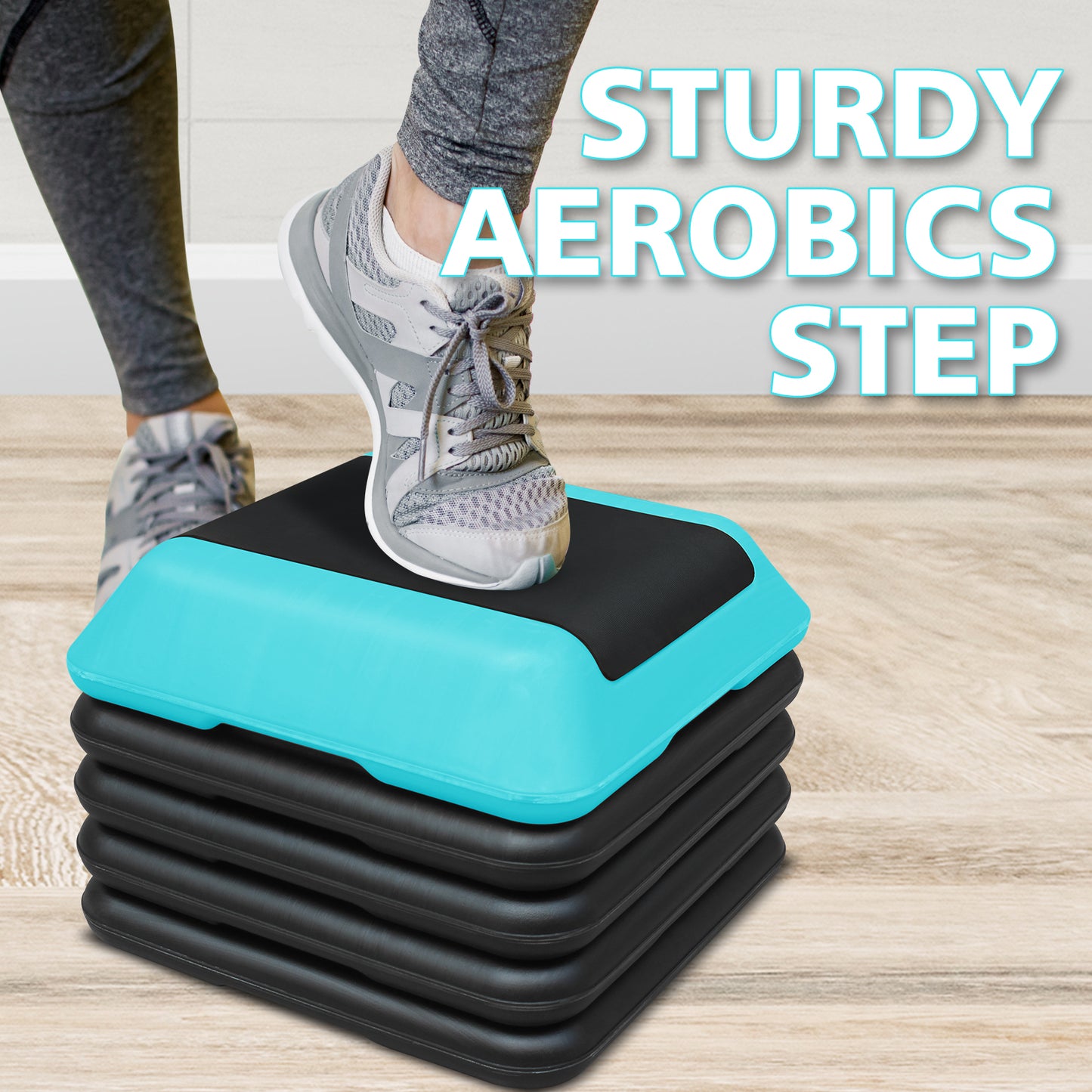 Stack of black aerobics step platforms with one teal top layer