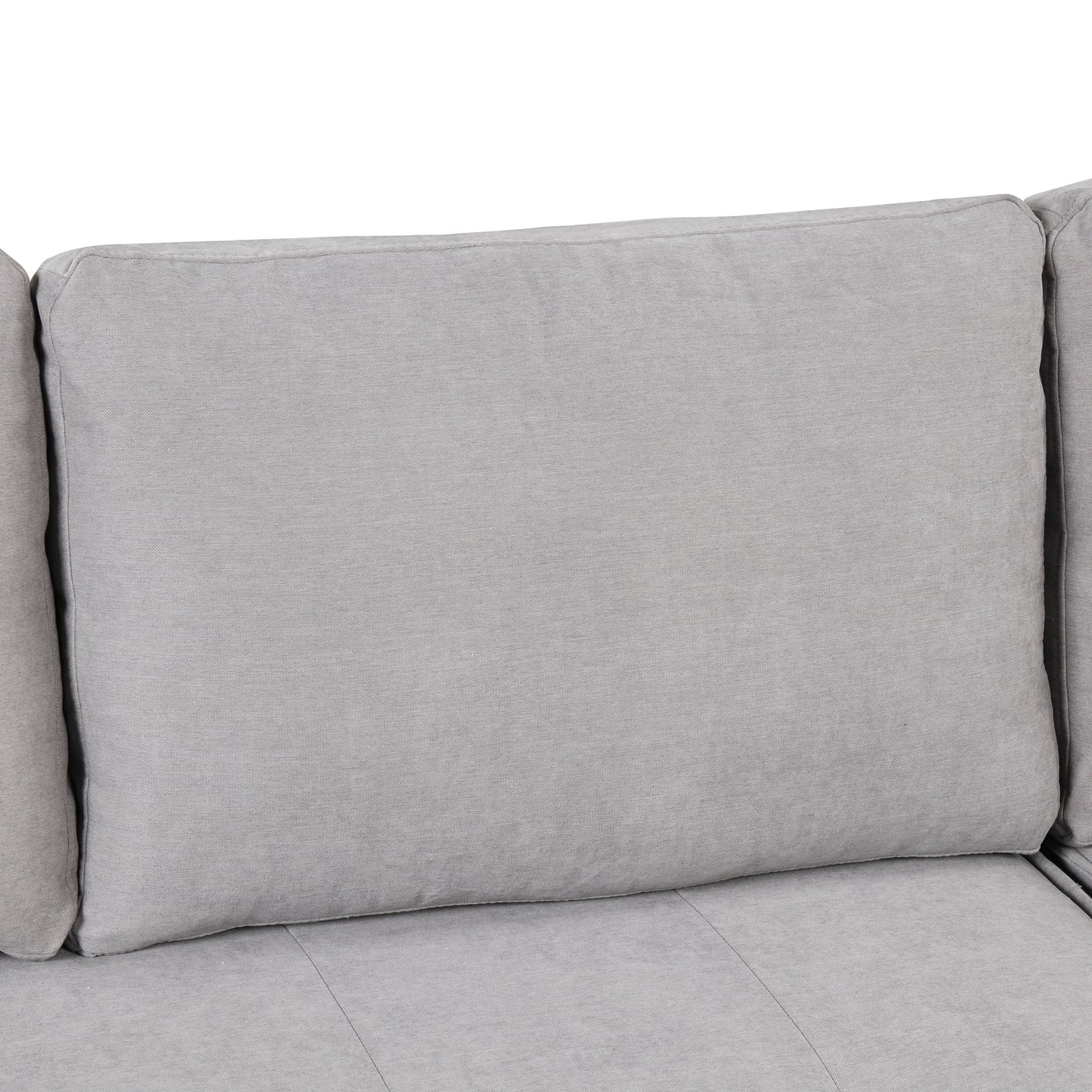 Closeup of a plush light gray fabric couch cushion showcasing its textured weave