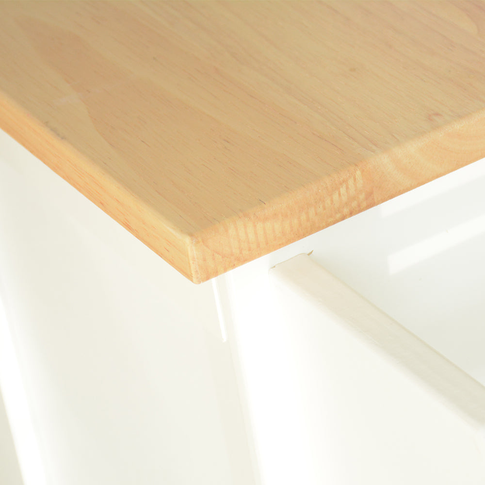 Closeup of a light wood countertop edge with a subtle grain pattern on a white base
