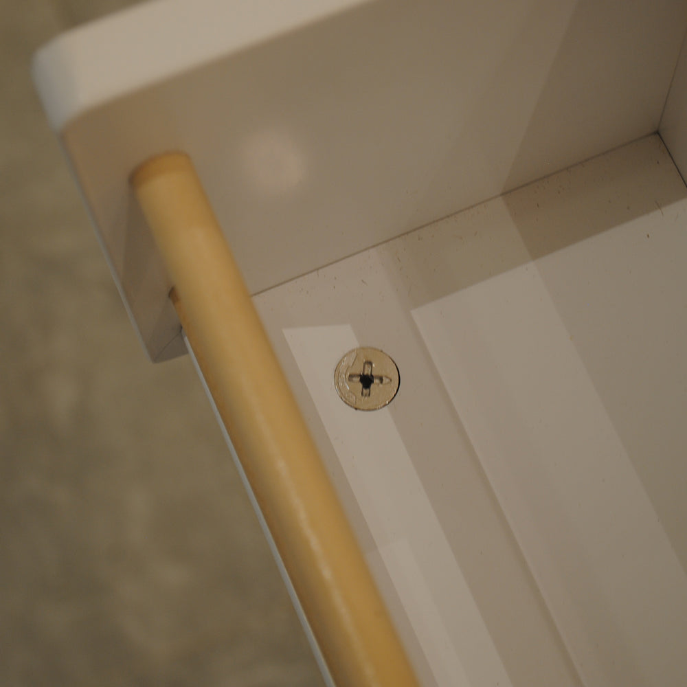 White shelf with wooden dowel and metal screw