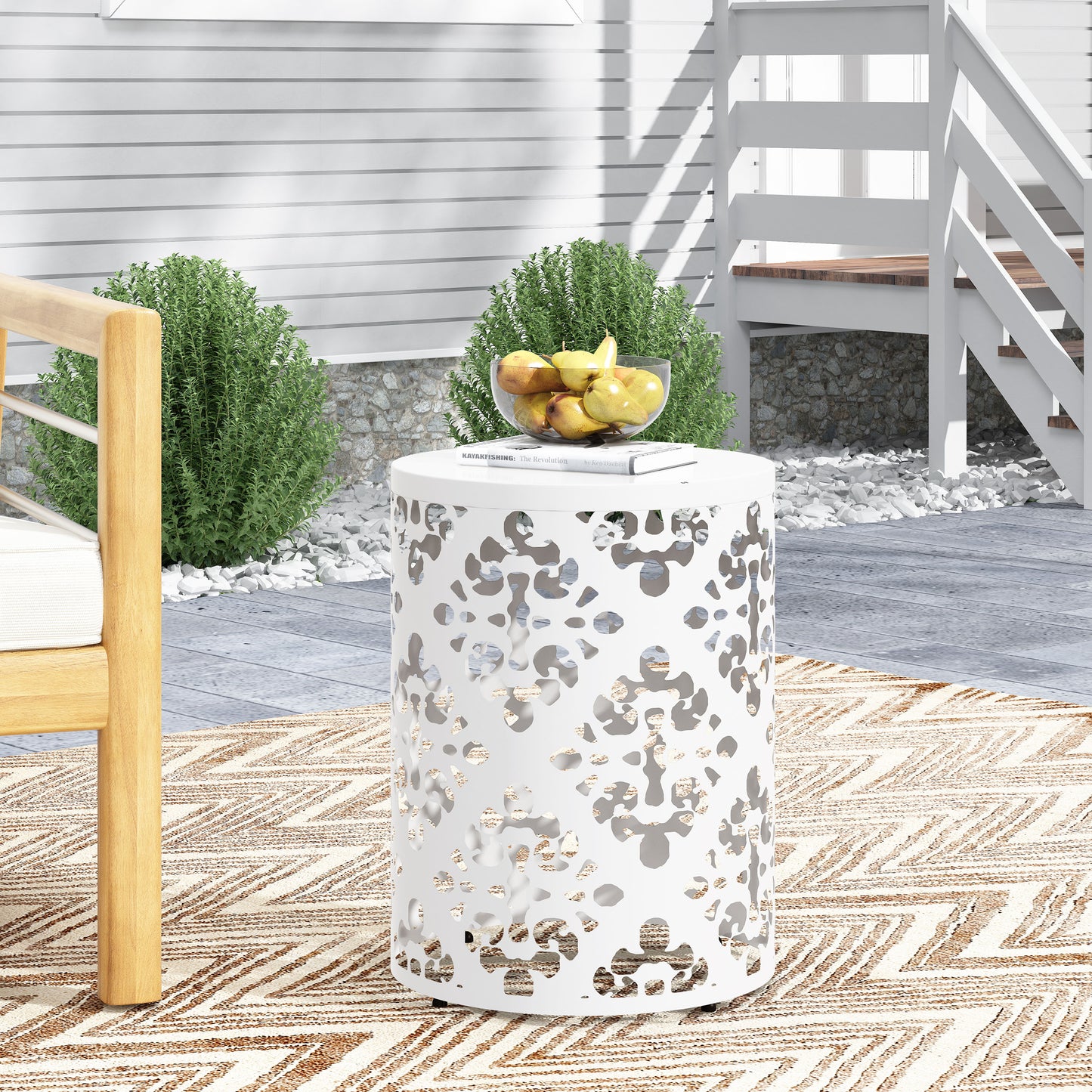 White metal outdoor accent table with a lasercut floral pattern perfect for patios
