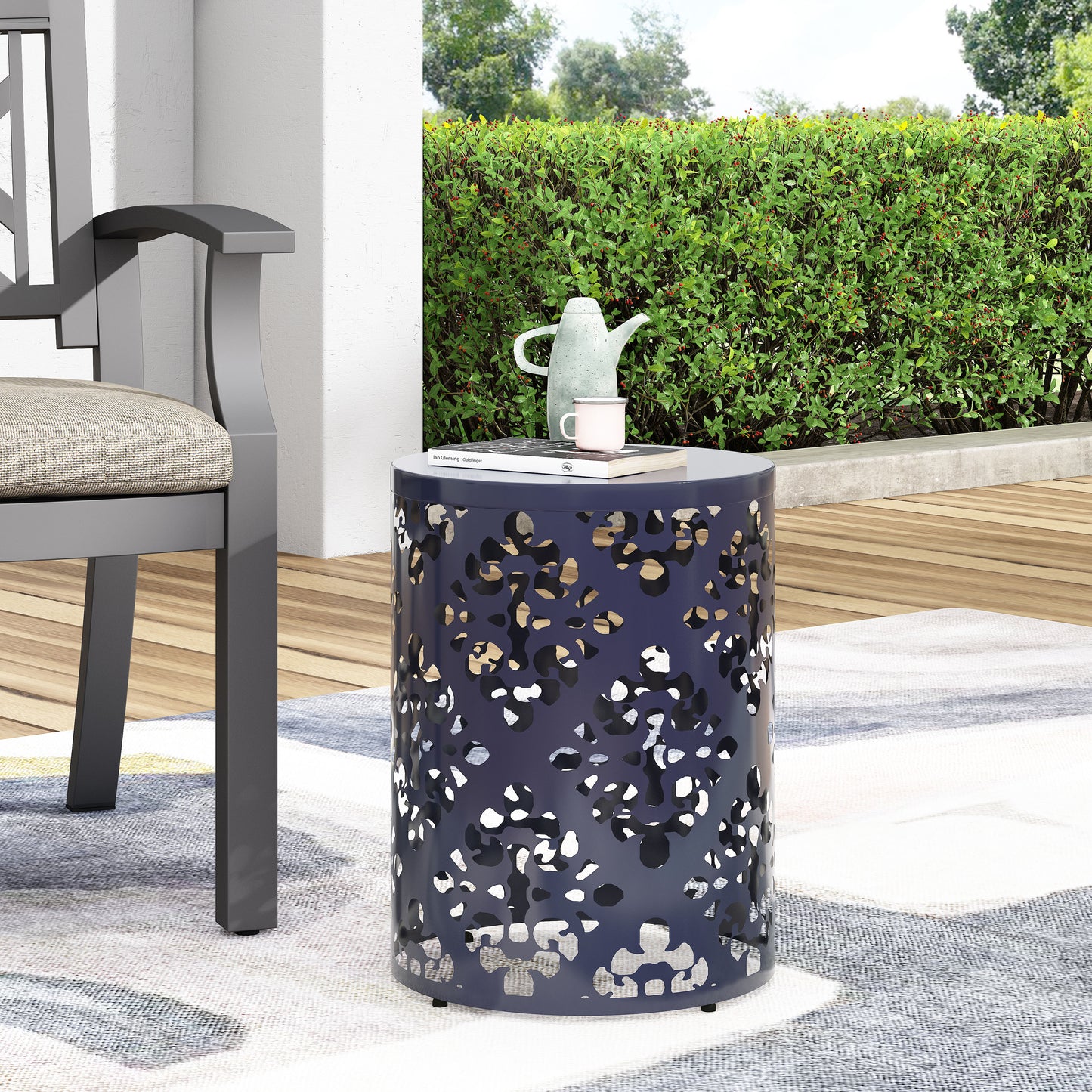 Dark blue metal garden side table with a lasercut abstract pattern