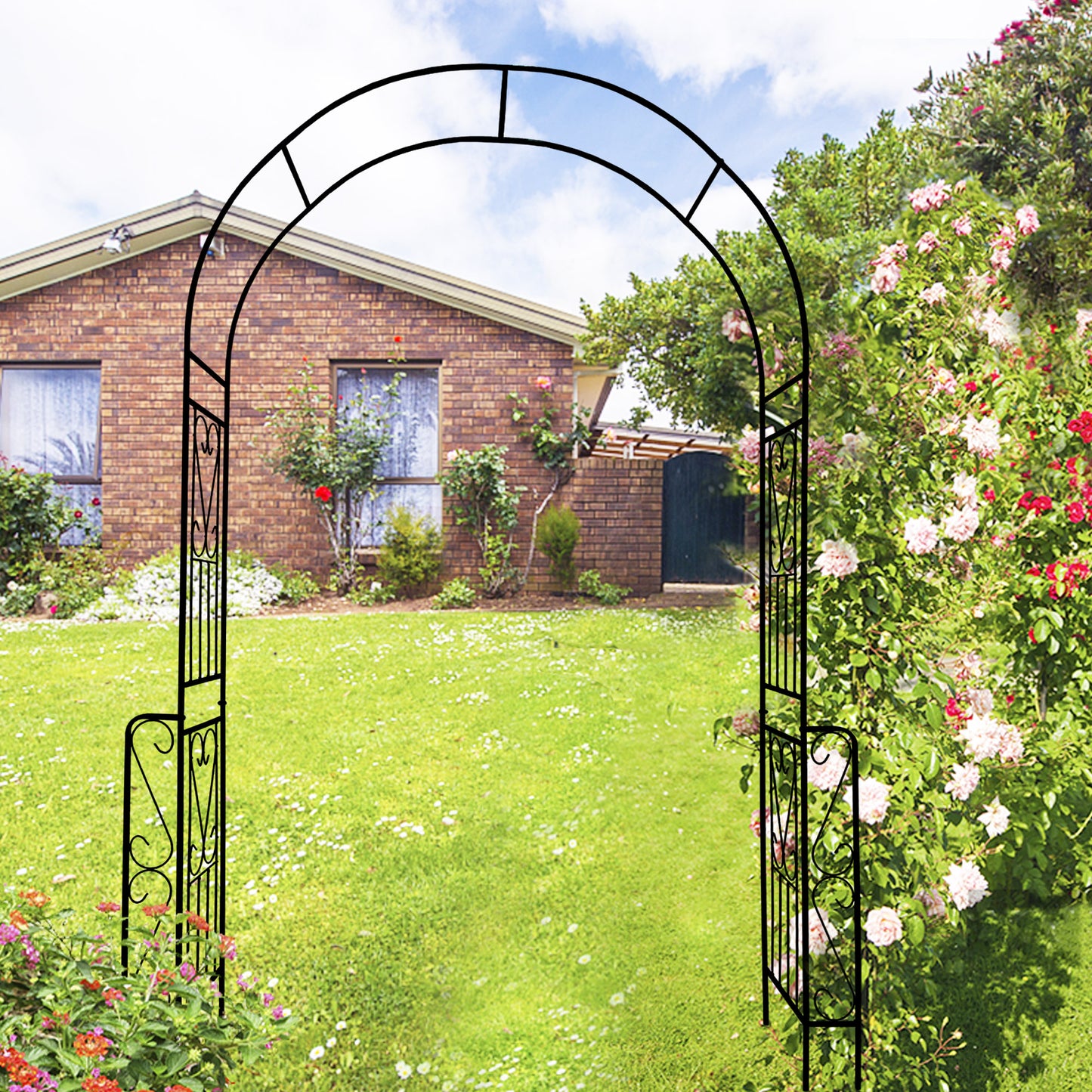 Black metal garden arch with ornate scrollwork ideal for a wedding or pathway