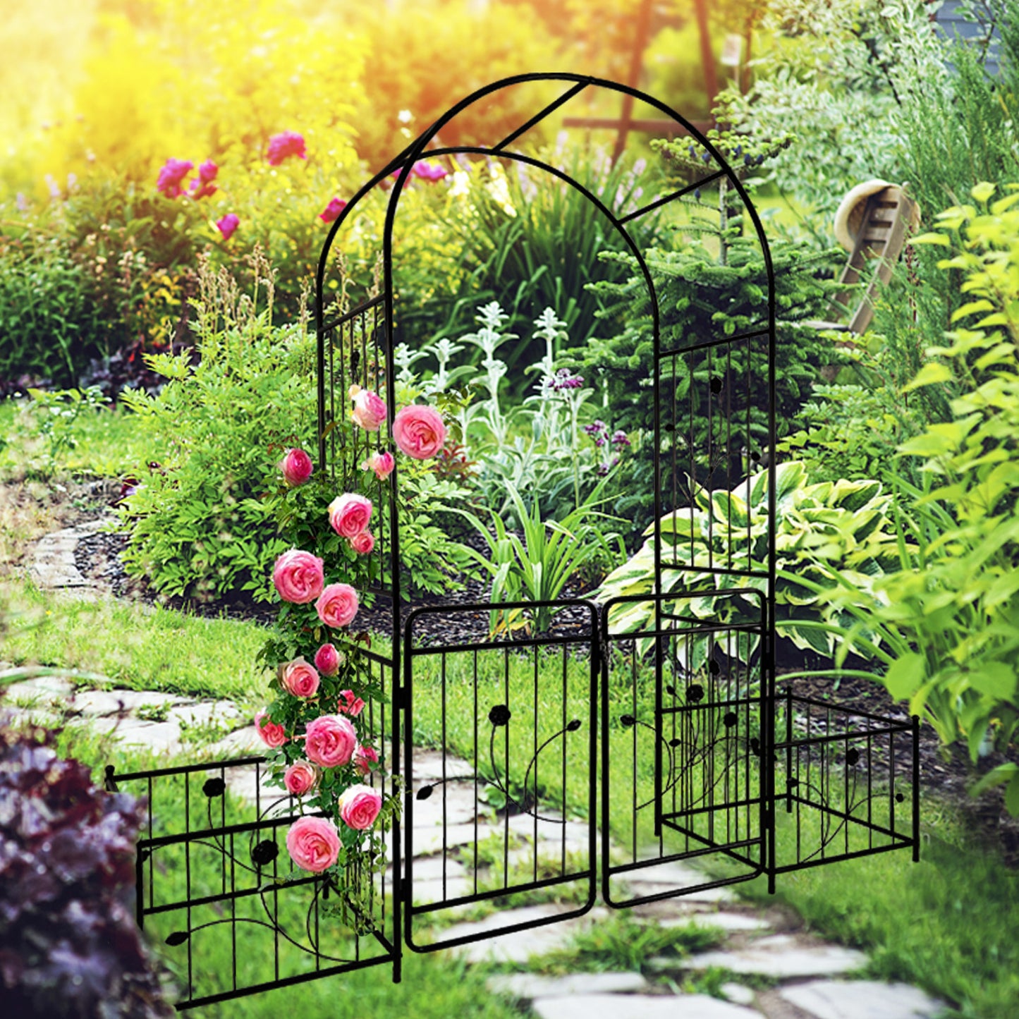 Black metal garden arch with blooming pink roses adding elegance to a backyard