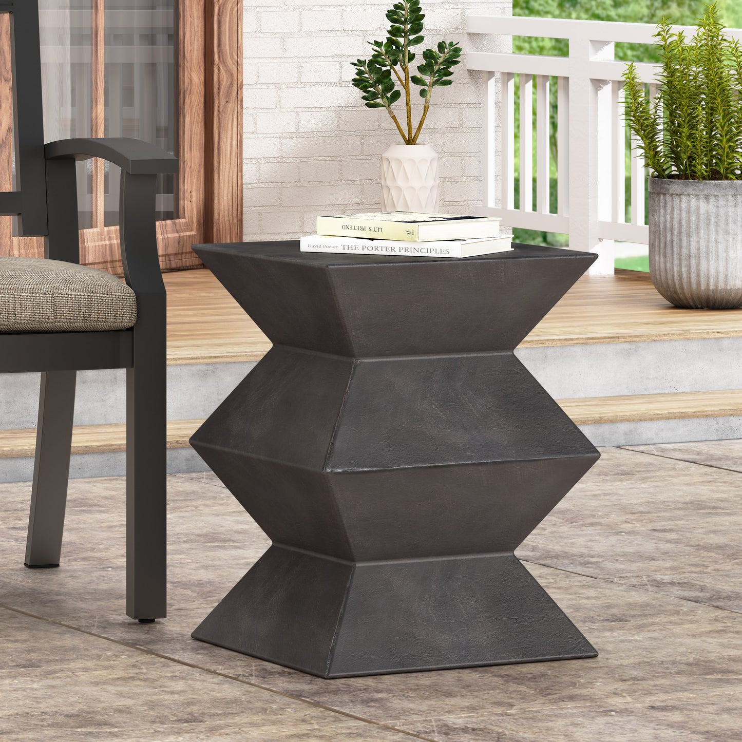 Charcoal hourglass accent table with modern geometric design ideal for patio use