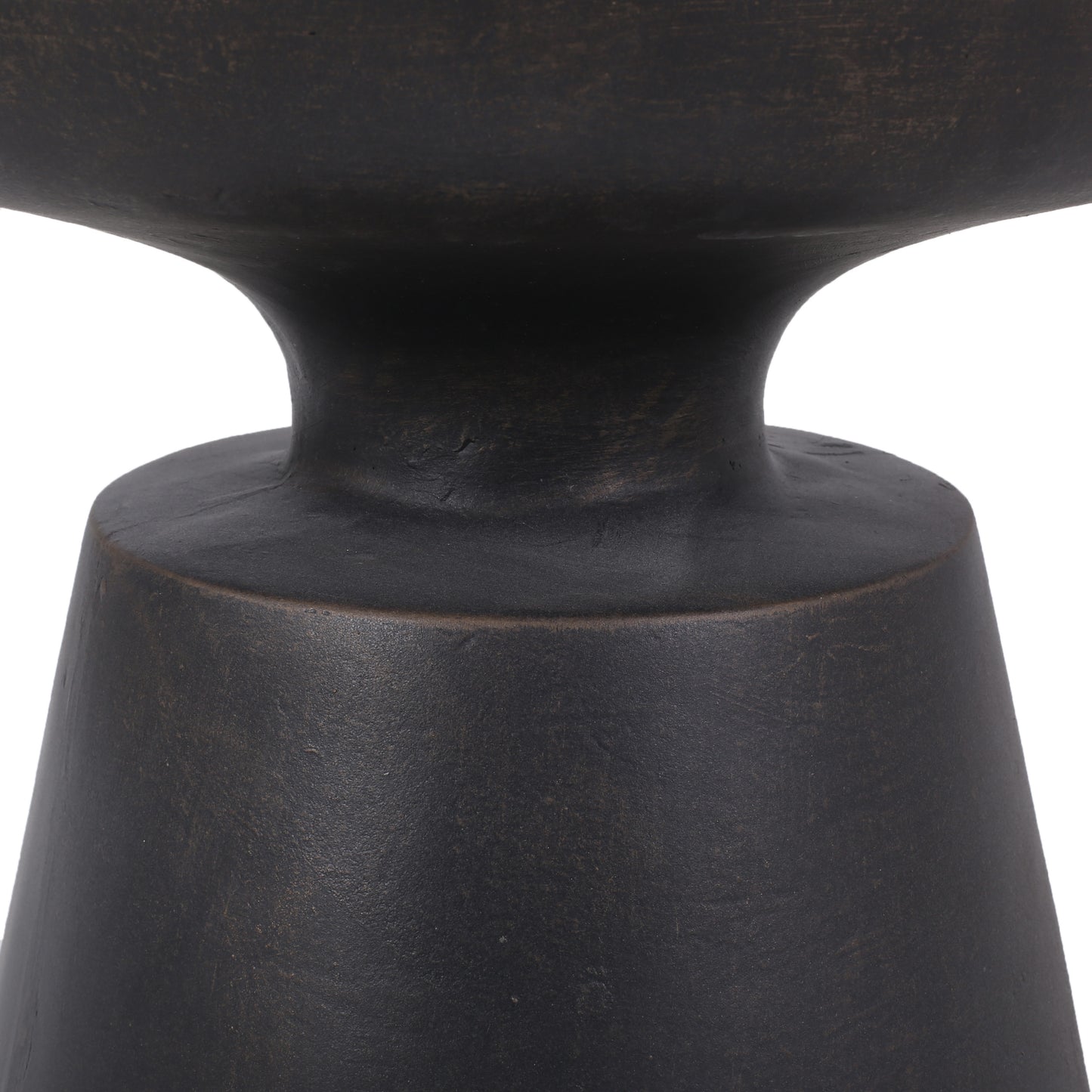 Closeup of a dark bronze metal vase base with textured detailing
