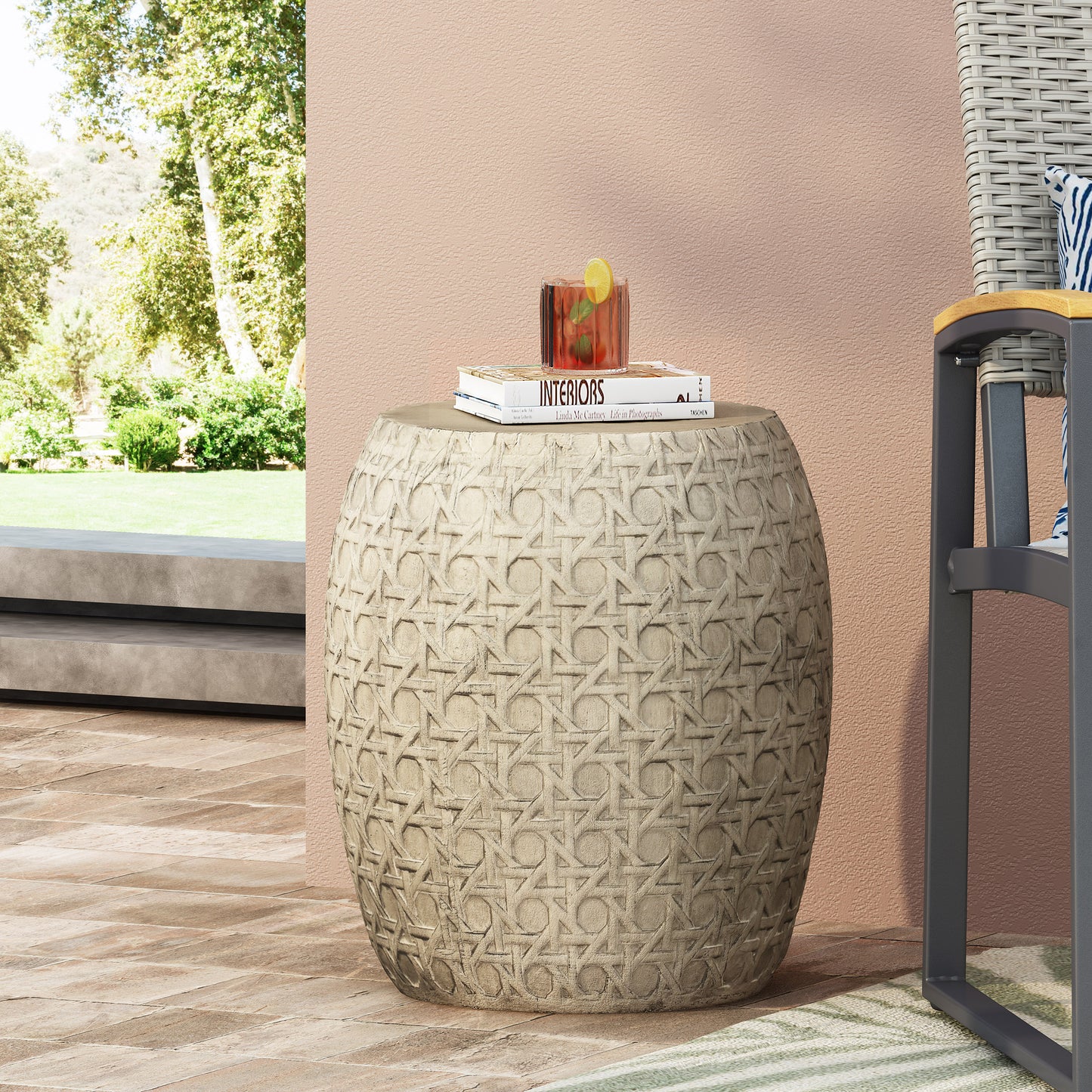 Round beige ceramic garden stool with intricate woven cane pattern perfect as outdoor accent furniture
