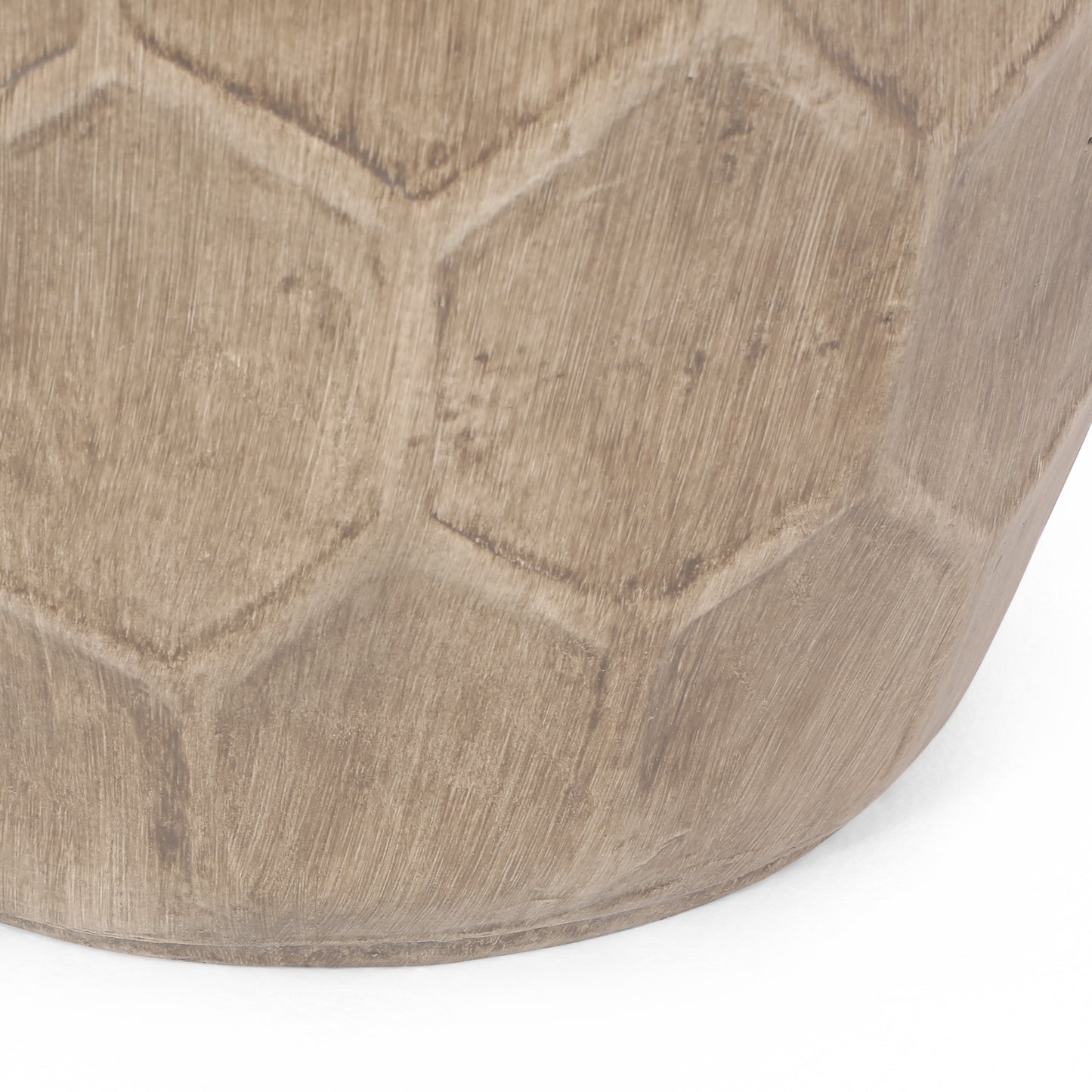 Closeup of a textured ceramic vase in taupe with a subtle hexagonal pattern