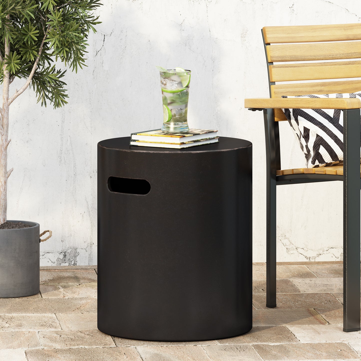 Black cylindrical outdoor accent table with cutout handle for easy portability