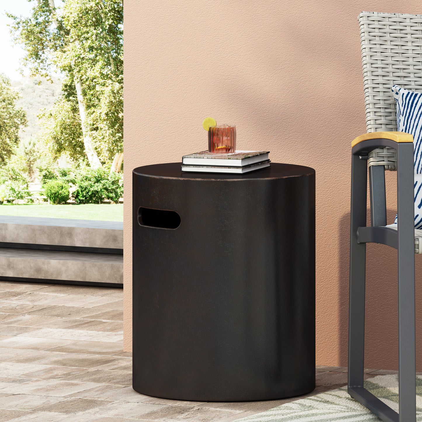 Dark gray cylindrical outdoor side table with cutout handle