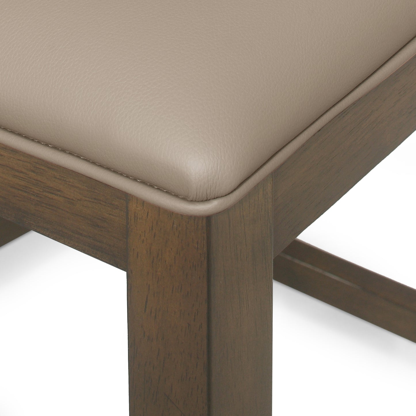 Closeup of a taupe leather bar stool seat with a dark wood frame