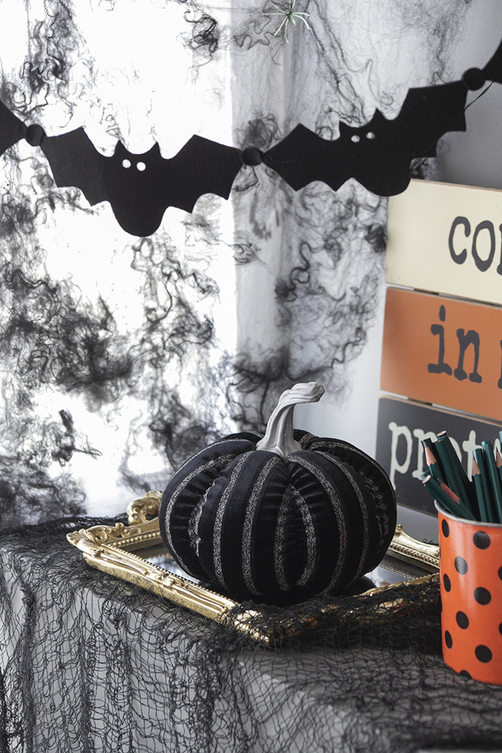 Black velvet Halloween pumpkin with silver stripes on ornate gold frame
