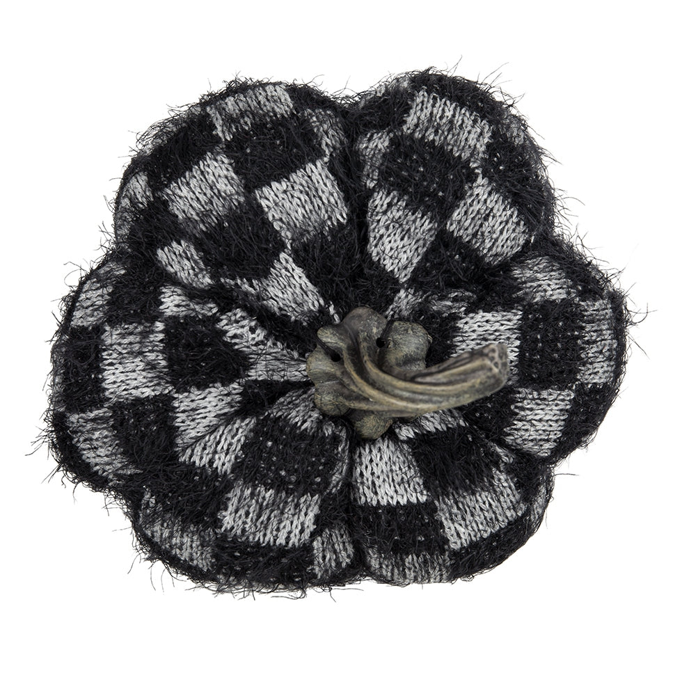 Black and white checkered knitted pumpkin with rustic stem
