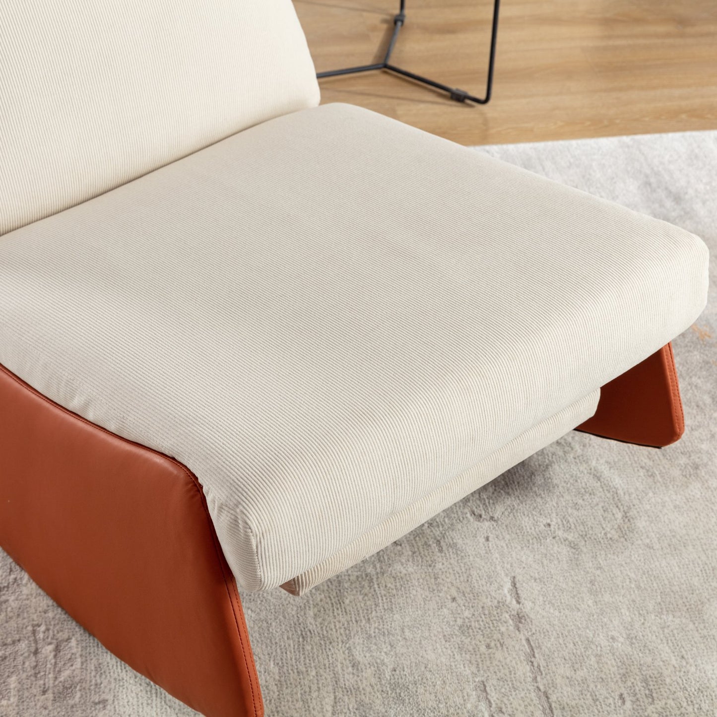 Cream corduroy armchair with rich tan leather base