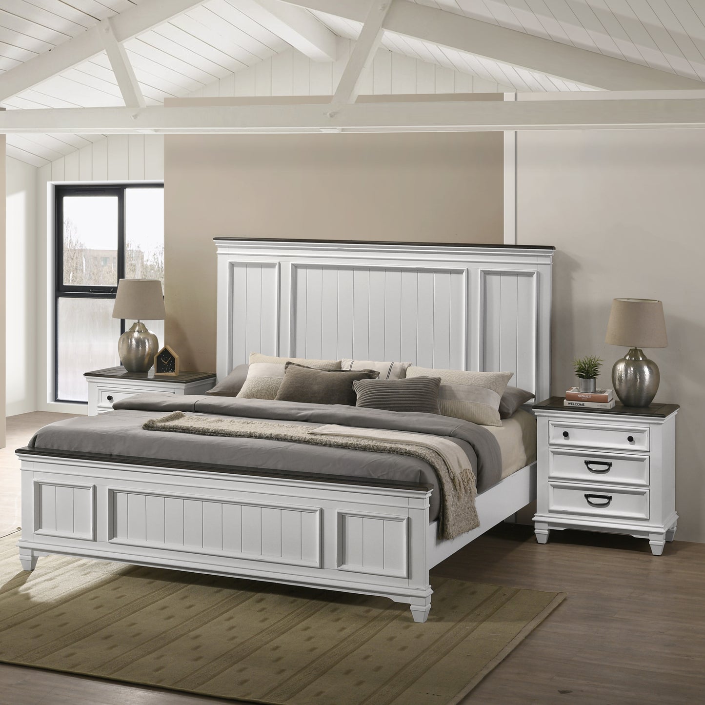 White paneled bed frame with dark wood accents and grey bedding