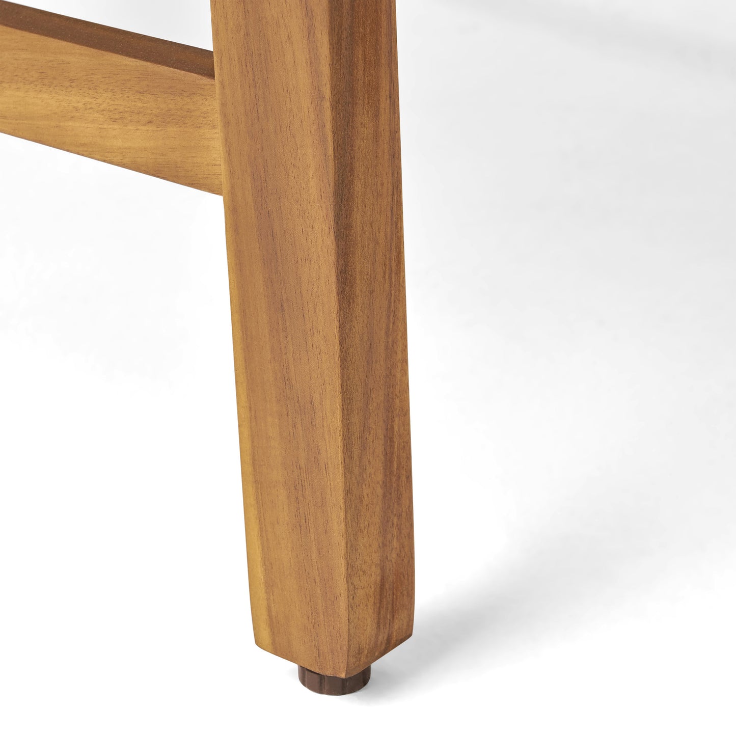 Closeup of a sturdy warmtoned solid wood table leg with a small dark brown floor protector