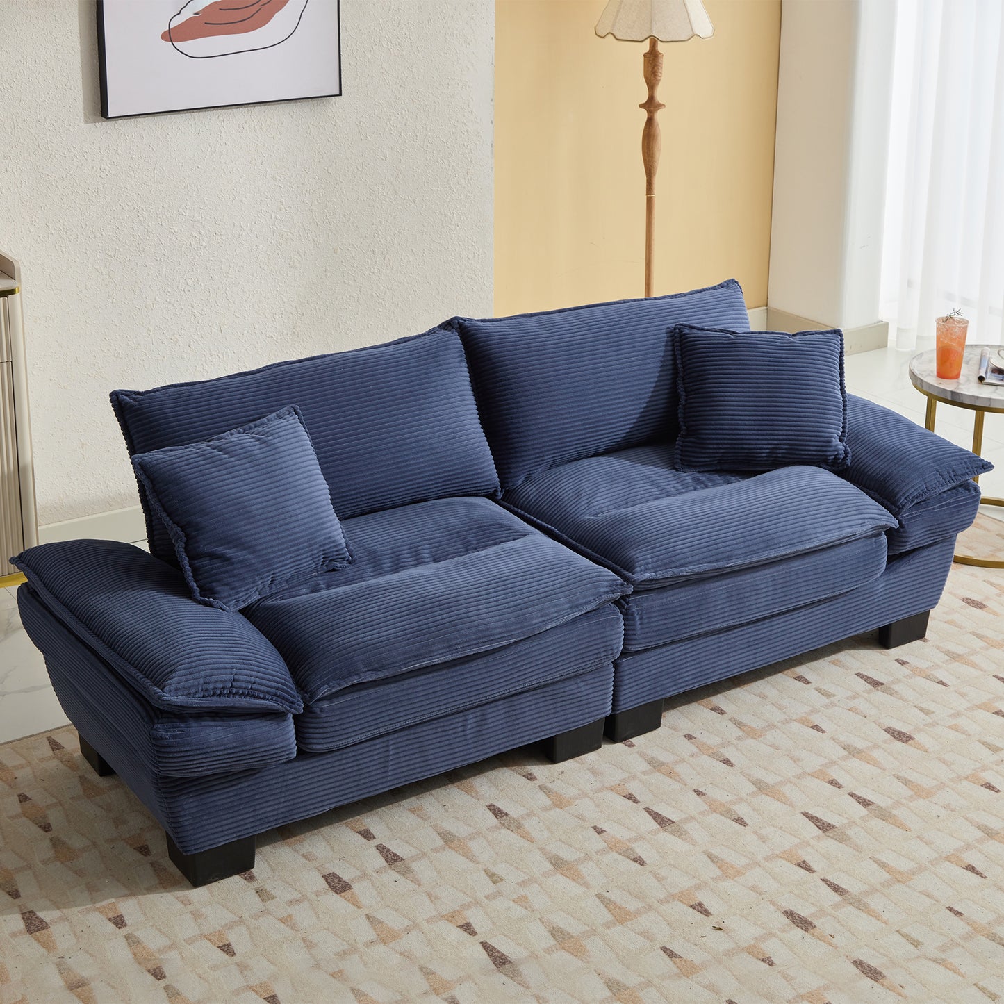 Deep blue corduroy sofa with plush cushions and matching throw pillows perfect for a cozy living room