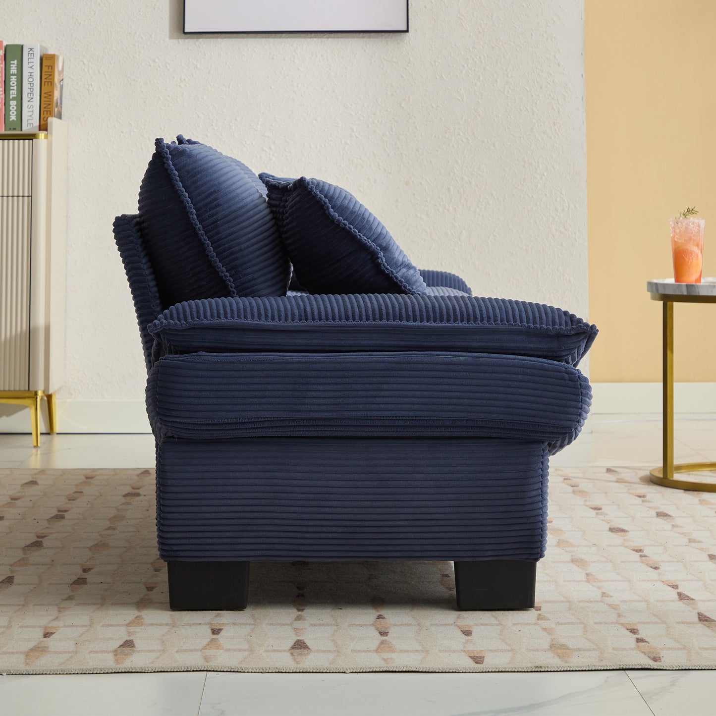 Deep navy blue corduroy sofa with plush cushions and a modern lowprofile design