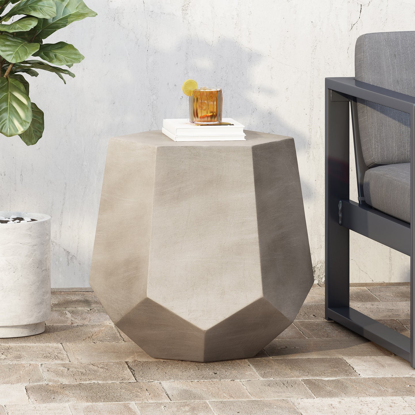 Geometric concrete side table with faceted design and minimalist style
