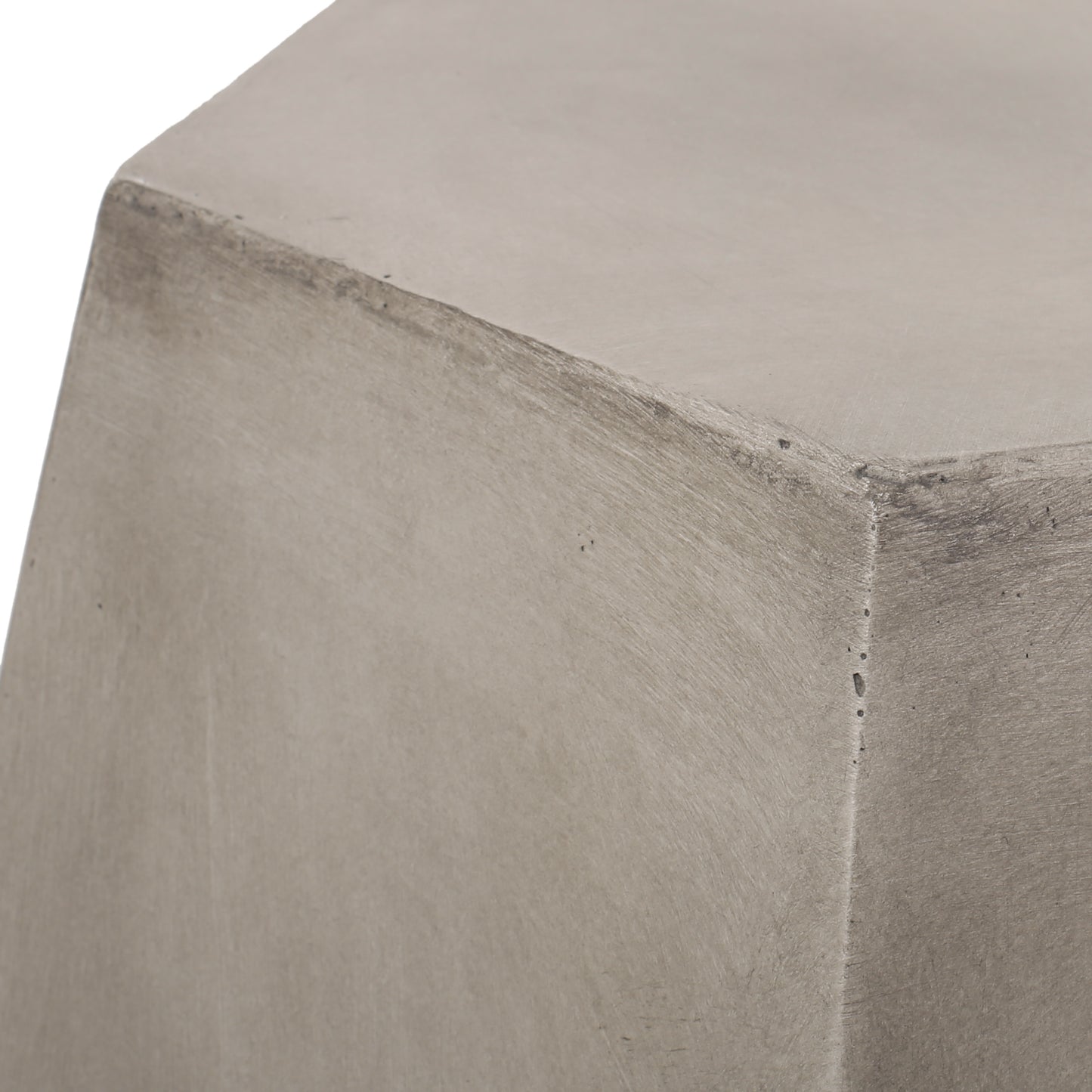 Closeup of a textured gray concrete block with subtle imperfections