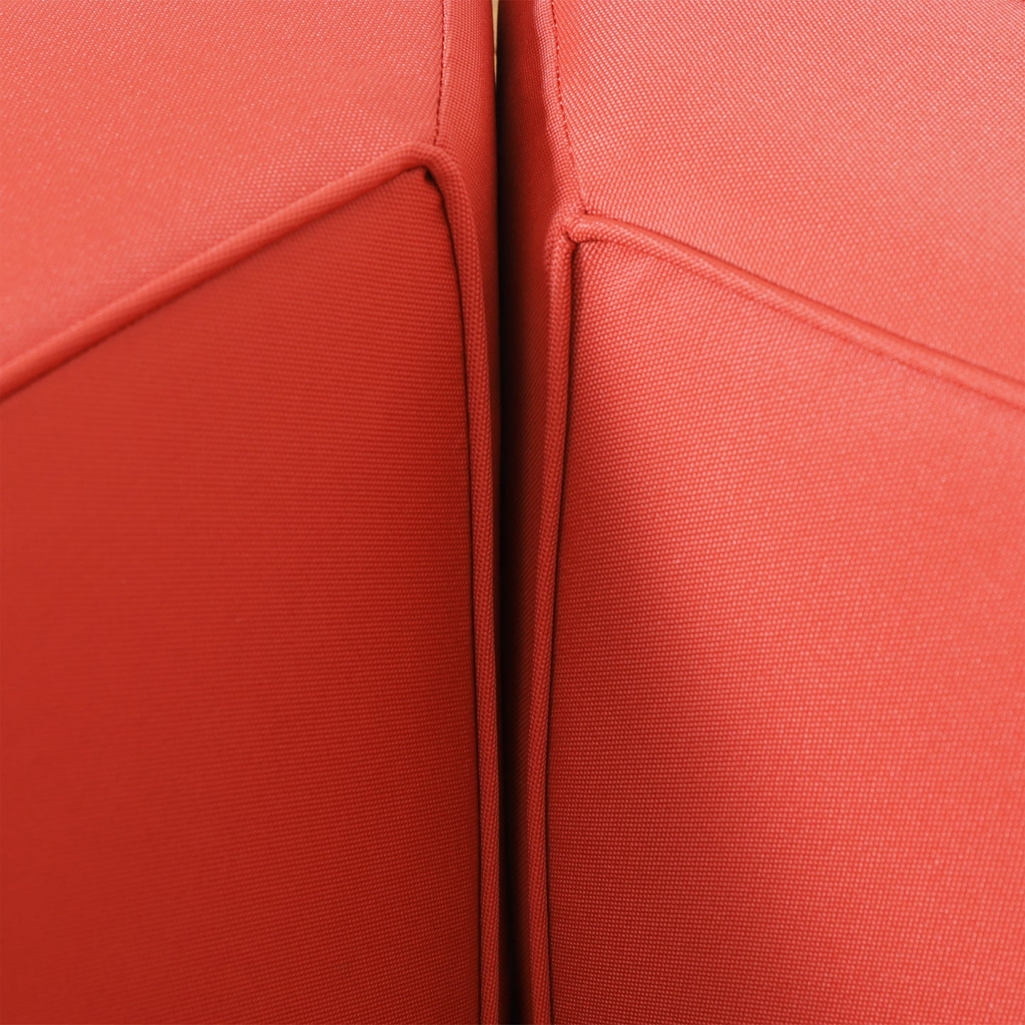 Closeup of textured red outdoor furniture cushion fabric providing durability