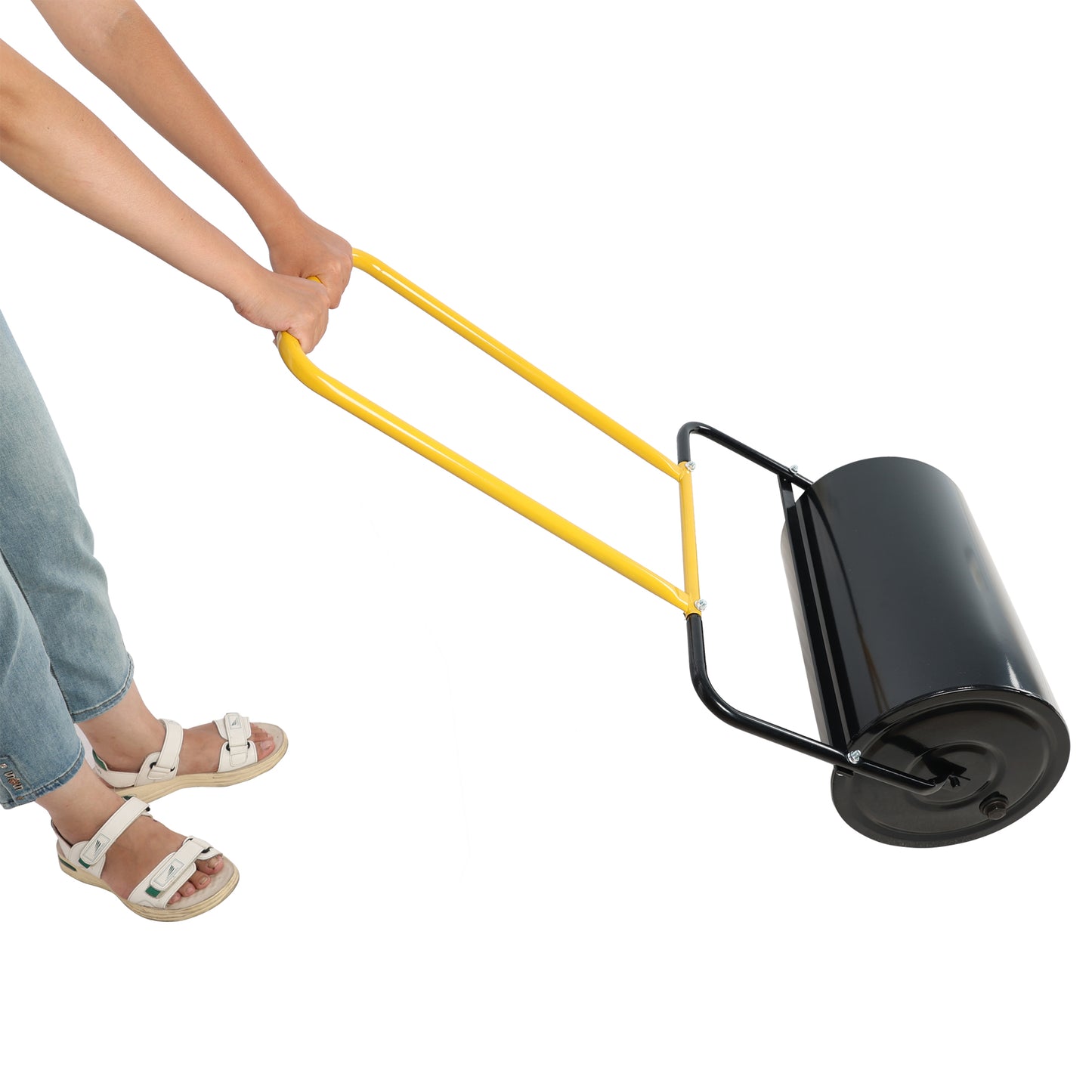 Black metal lawn roller with yellow handles being pulled by person
