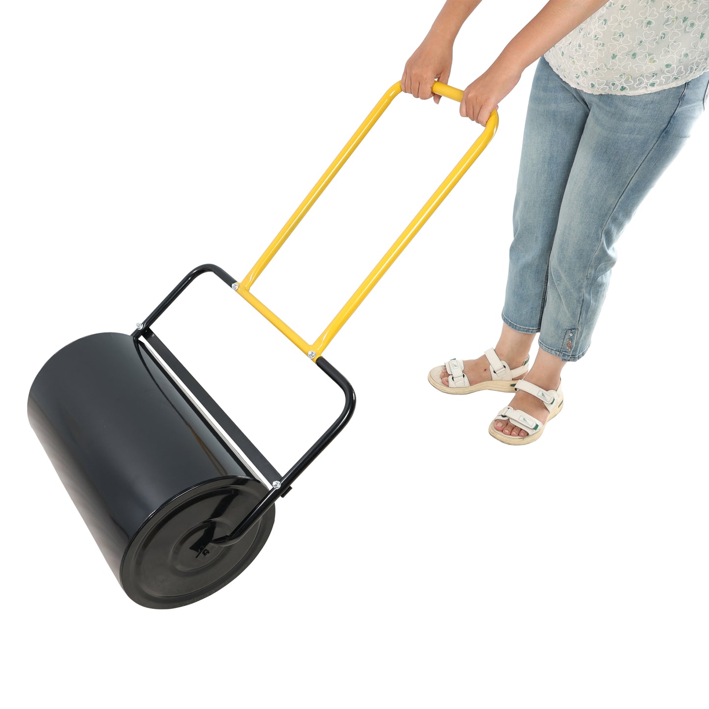 Black lawn roller with yellow handle being pushed by person