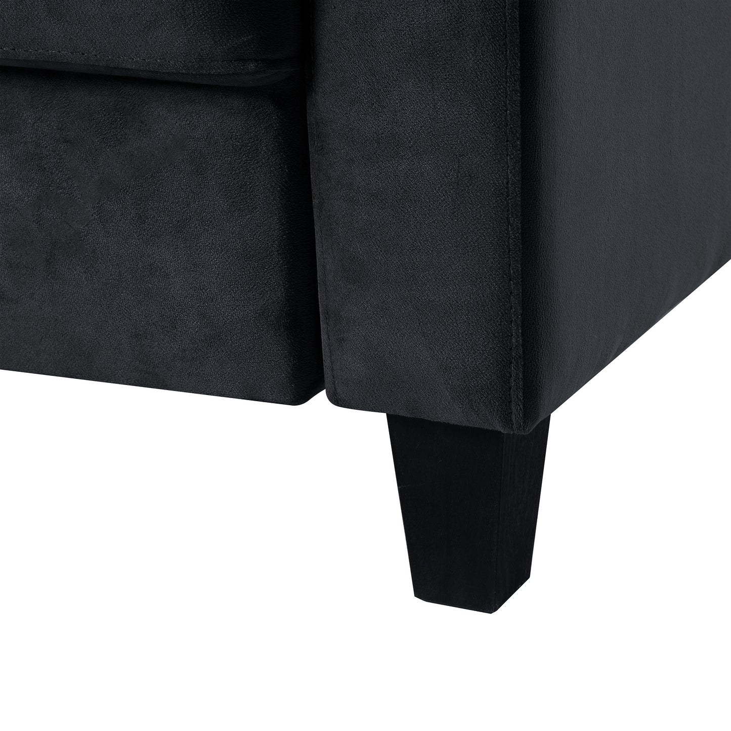 Closeup of black velvet sofa armrest with square wooden leg