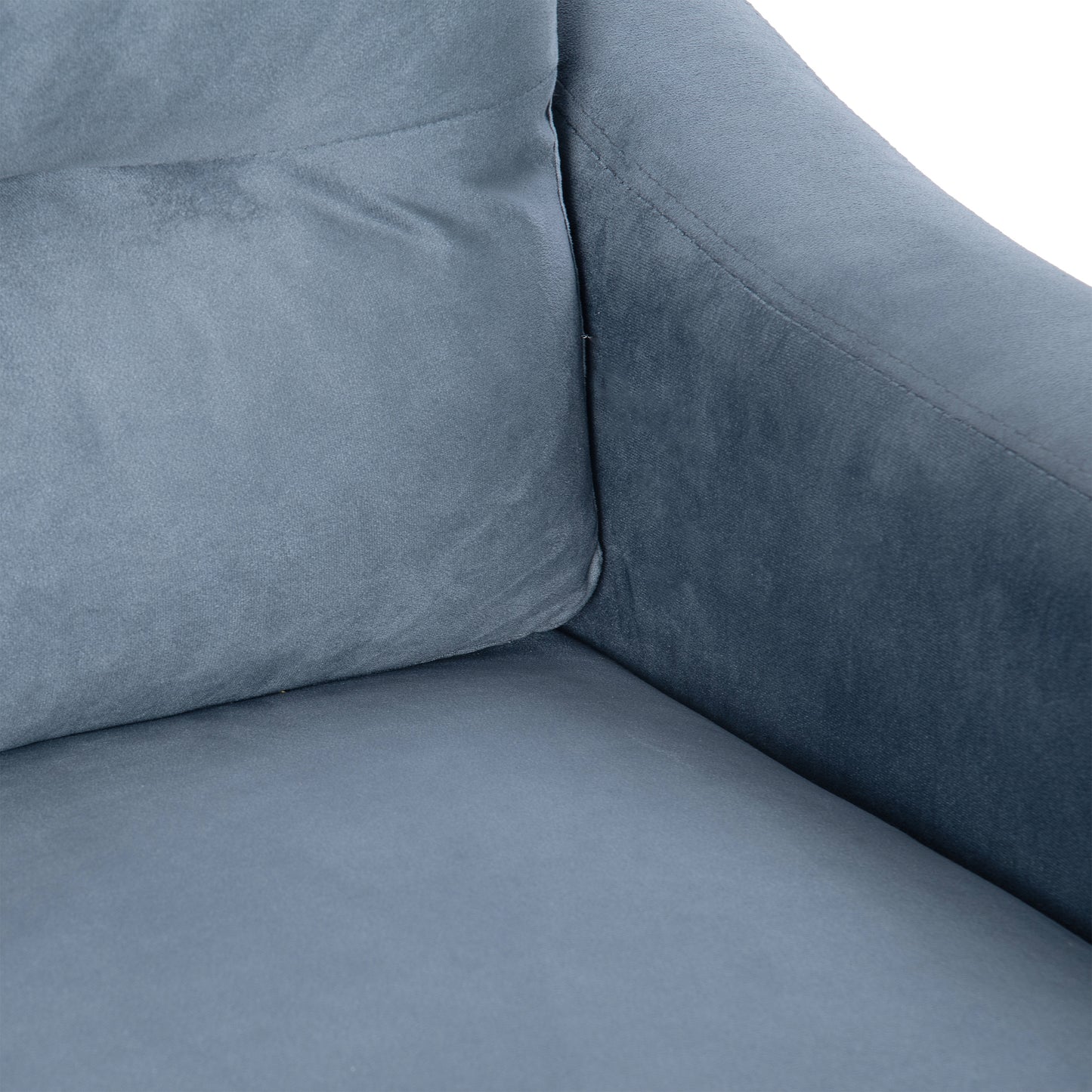 Closeup of a plush slate grey velvet sofa cushion with visible stitching