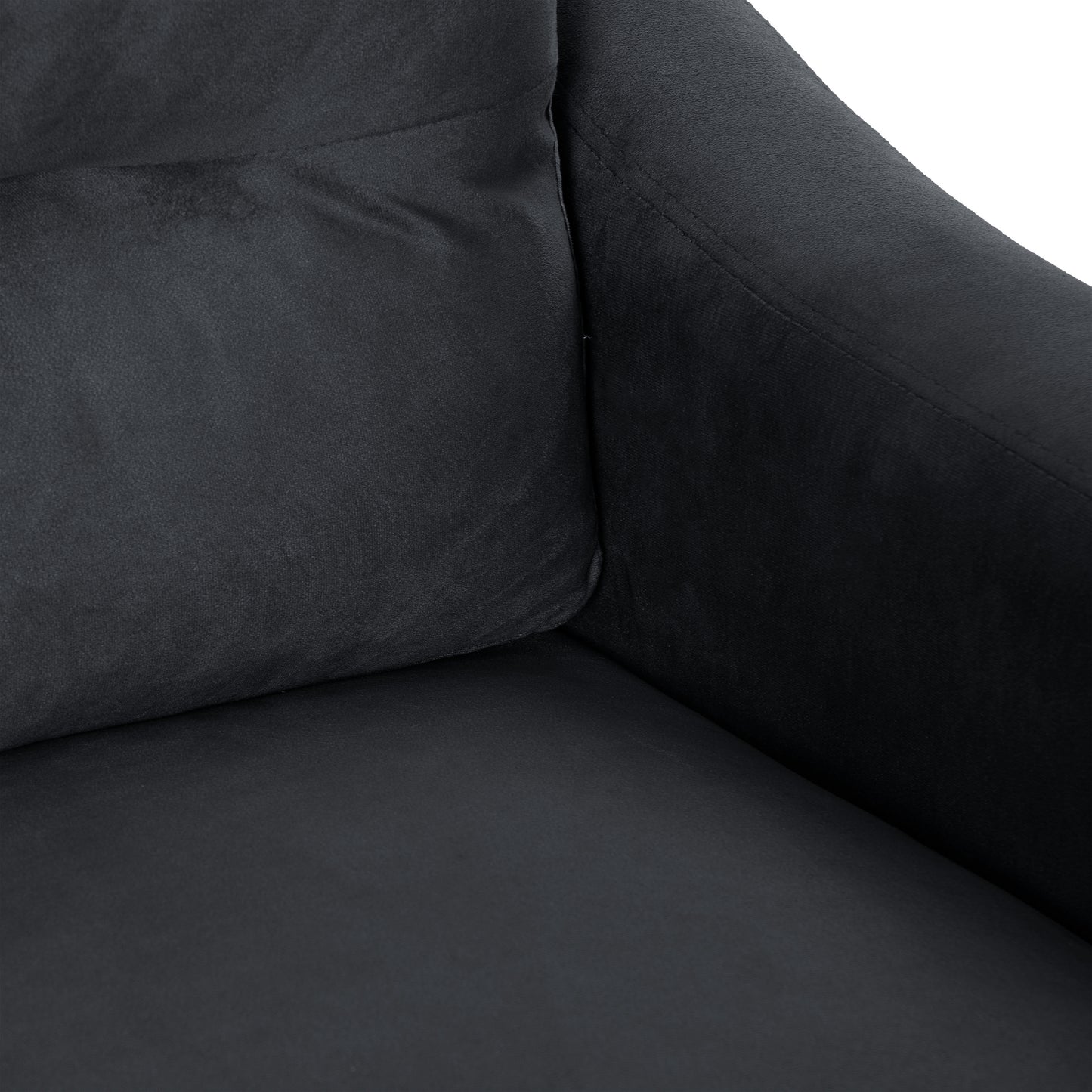 Dark charcoal velvet upholstery texture detail on a modern armchair