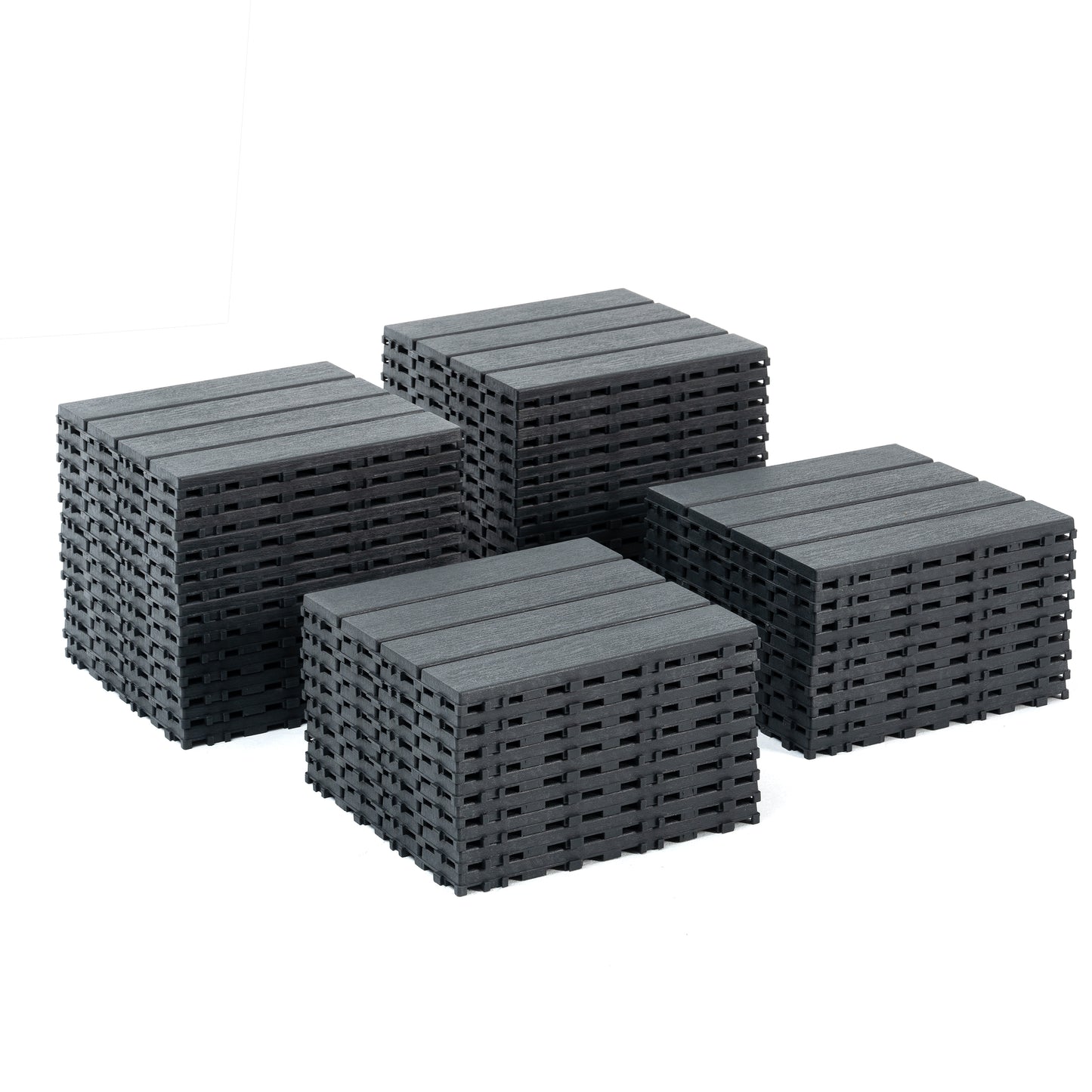 Dark grey composite decking tiles stacked in groups for outdoor patio use