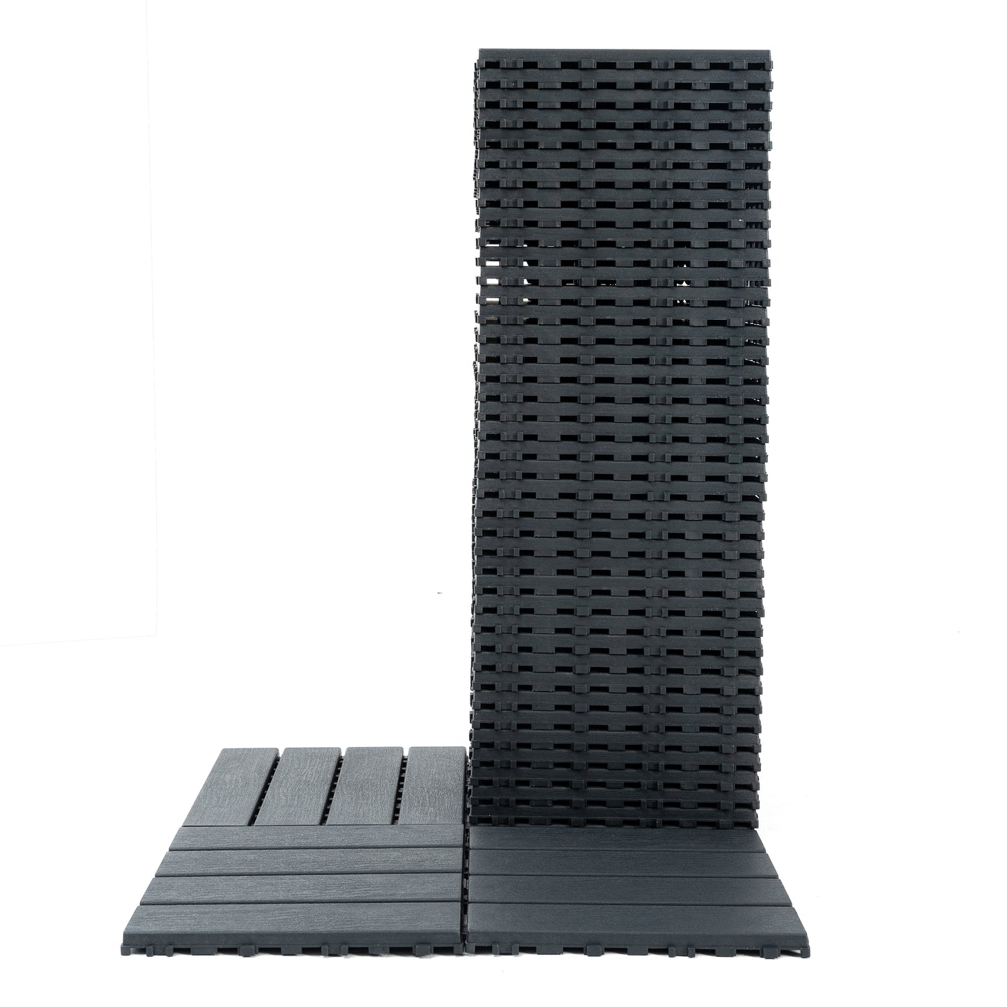 Stack of dark grey composite decking tiles designed for easy interlocking patio installation