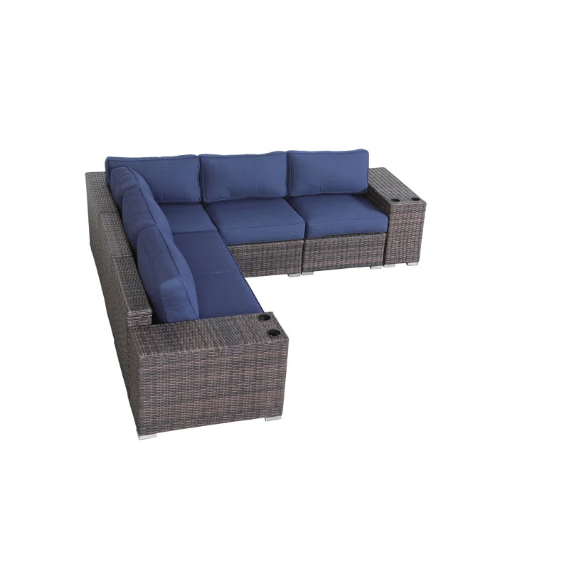 Brown wicker sectional outdoor sofa with navy blue cushions and builtin cup holders