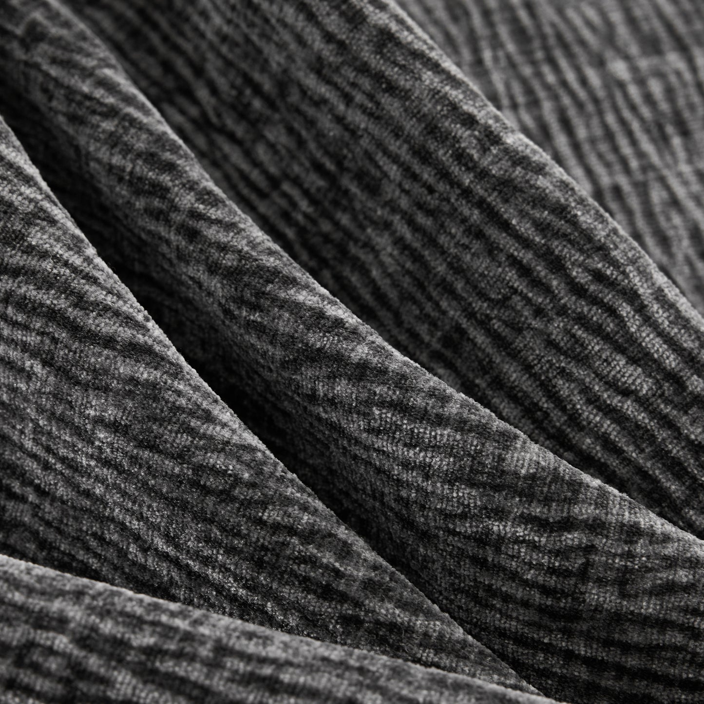 Closeup of plush gray velvet fabric with raised ribbed texture perfect for upholstery projects