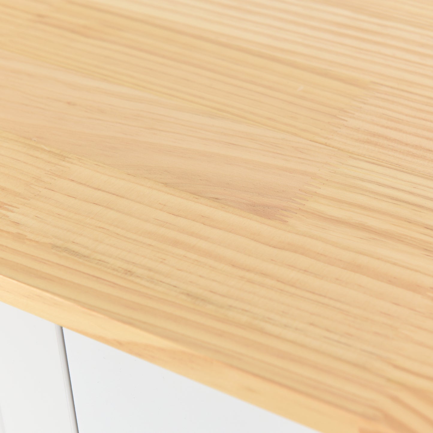 Light pine wood desktop texture with visible grain and edge detail
