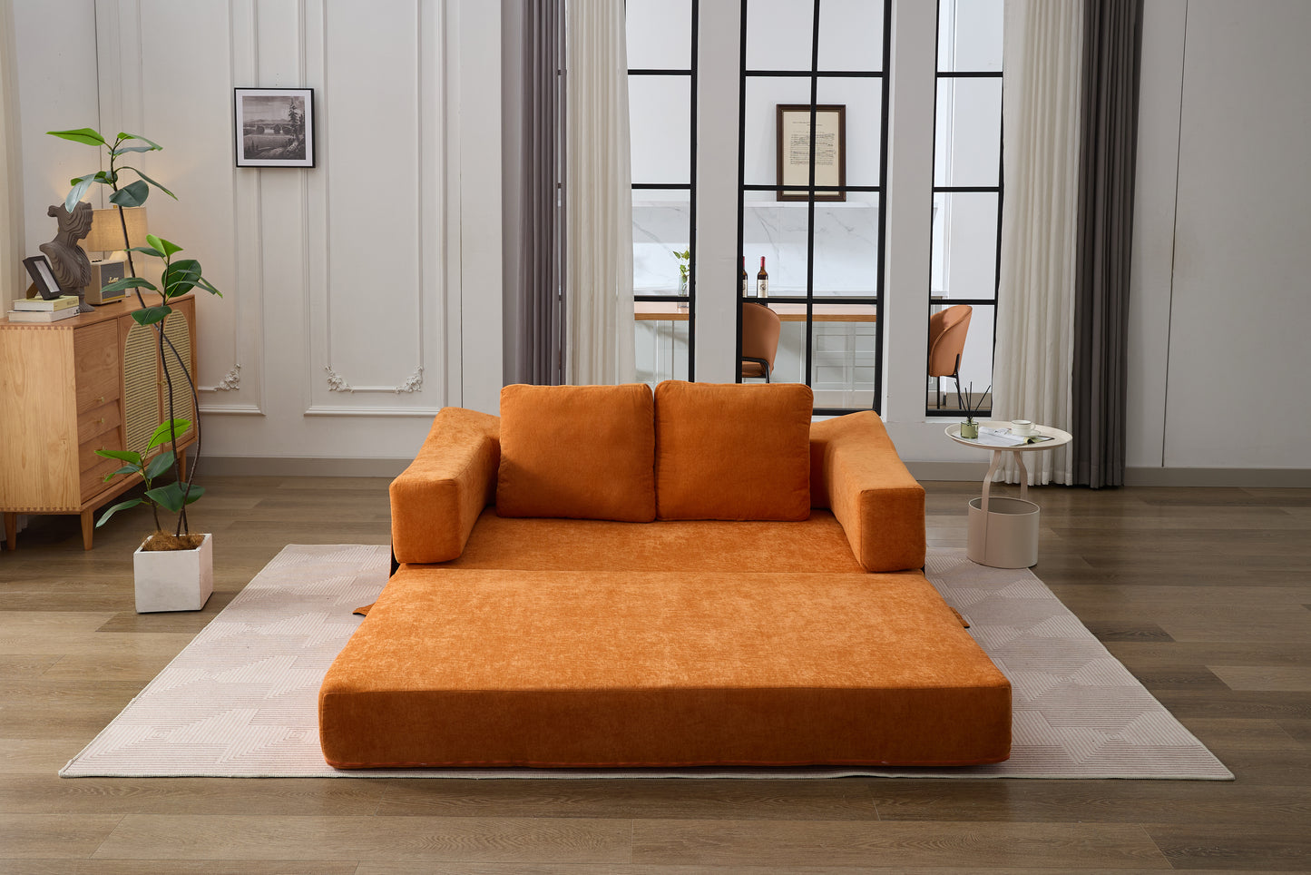 Orange convertible sofa with plush cushions easily transforms for seating and sleeping