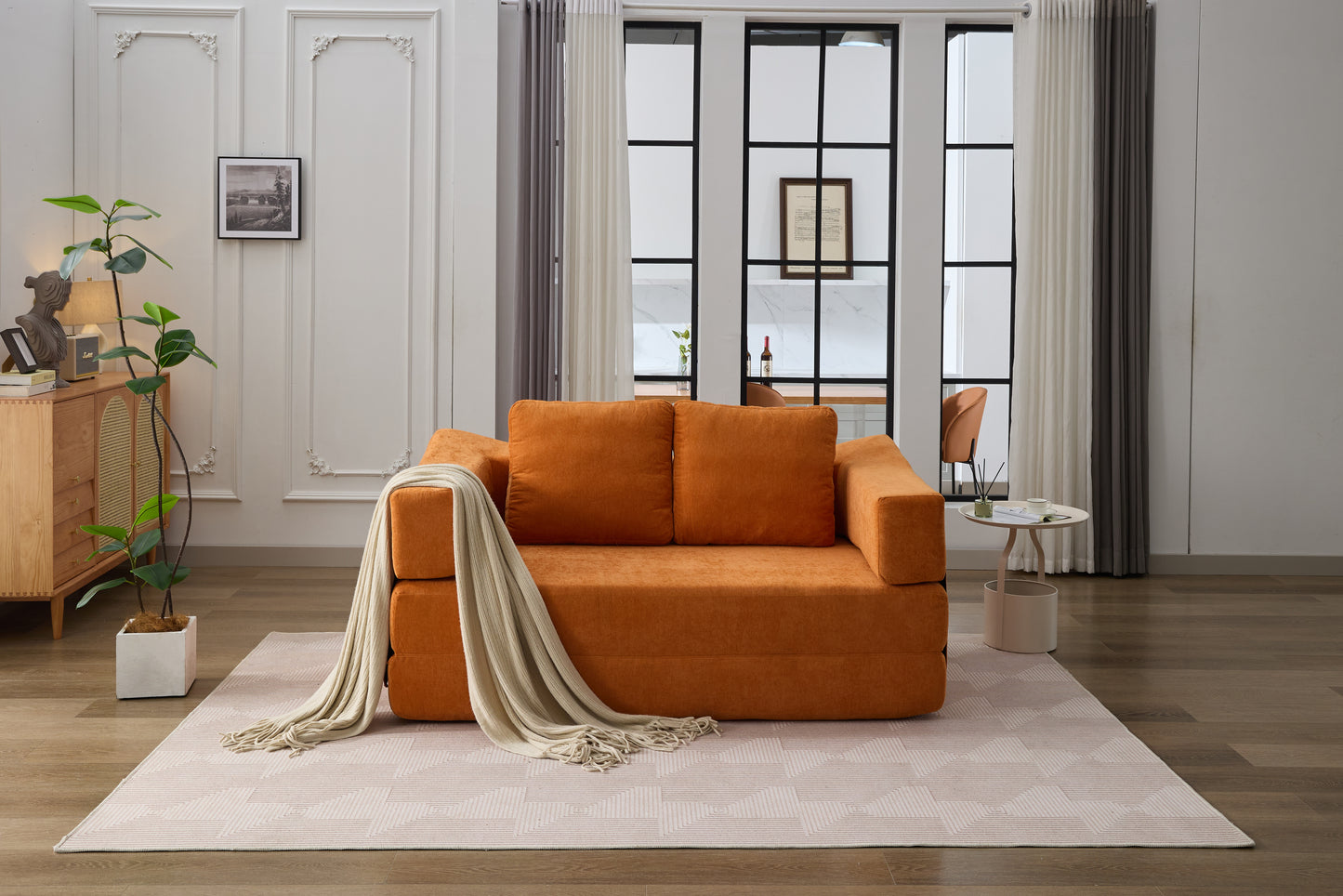 Orange fabric sofa with throw blanket ideal for modern living rooms