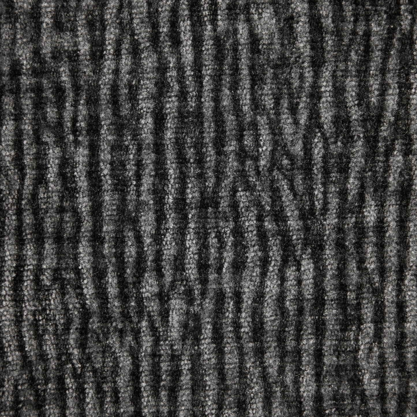 Closeup of textured dark grey carpet with ribbed pattern