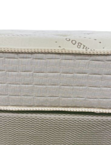 Closeup of a beige bamboo mattress cover with quilted texture and stitched edge