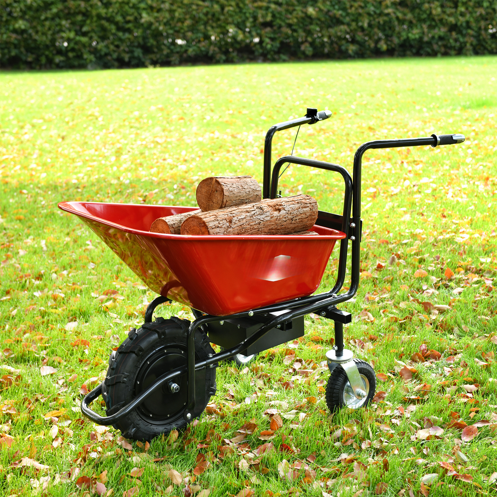 Red electric wheelbarrow loaded with logs on a grassy lawn