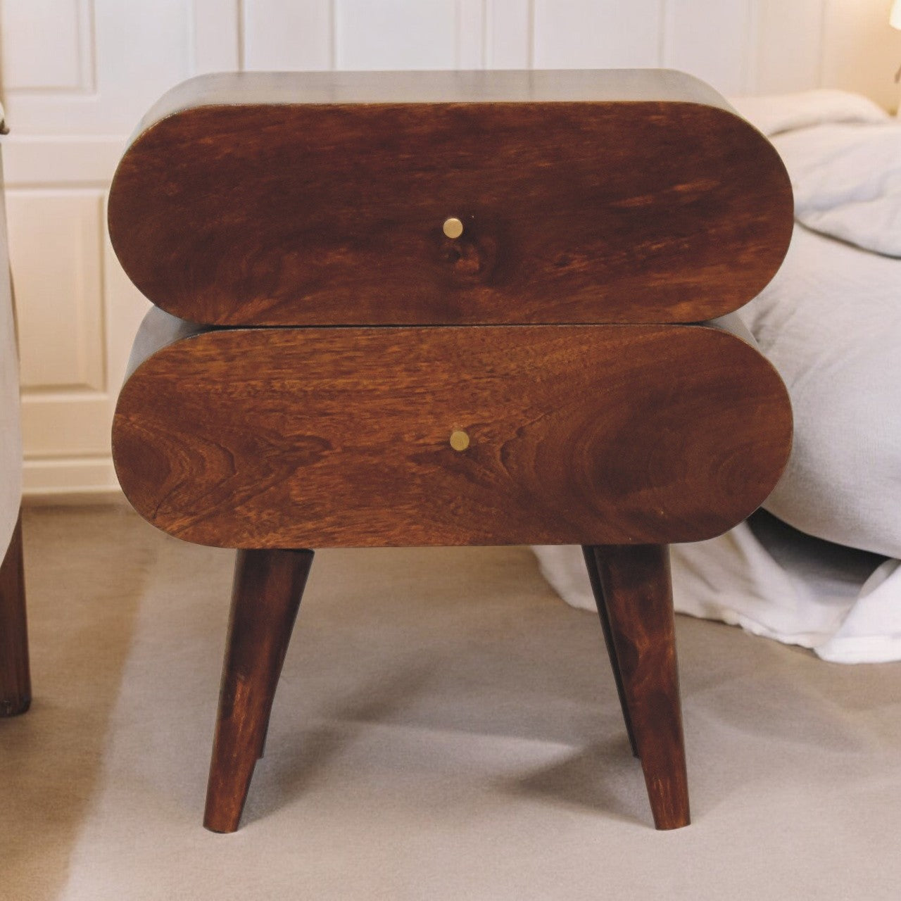 Rounded twodrawer wooden nightstand with brass knobs and tapered legs