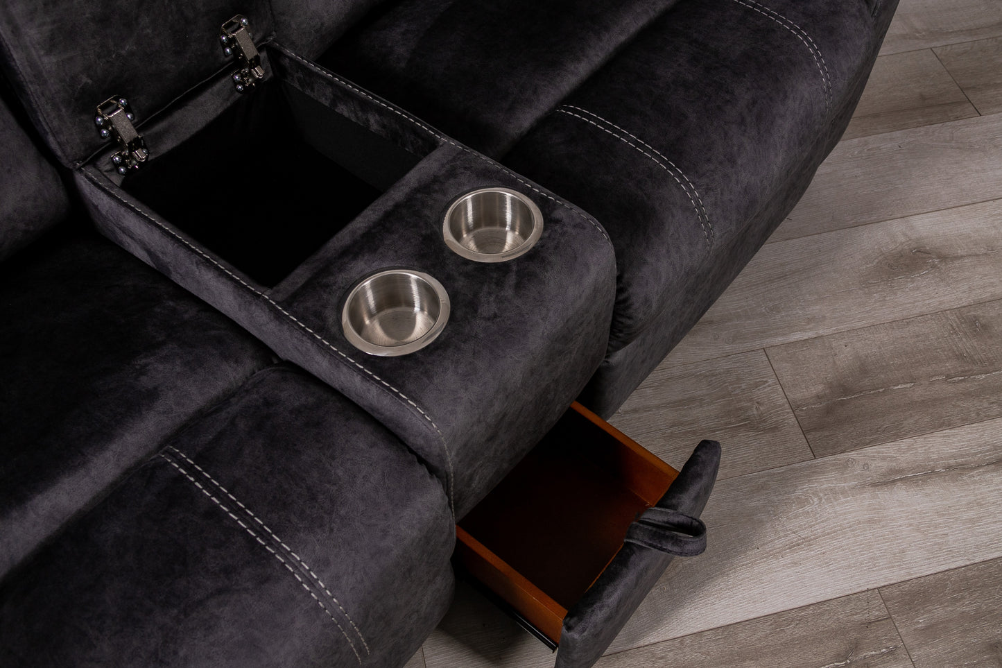 Dark gray recliner sofa section with open storage compartment and dual cup holders