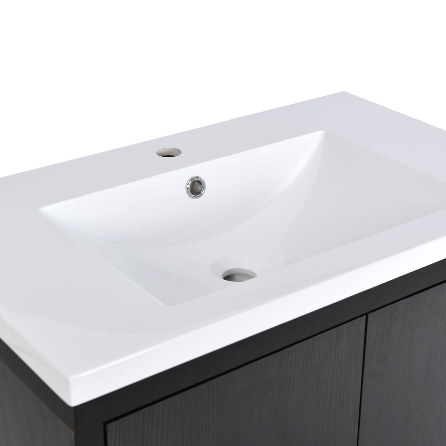 White ceramic undermount sink with chrome faucet hole on a dark wood vanity