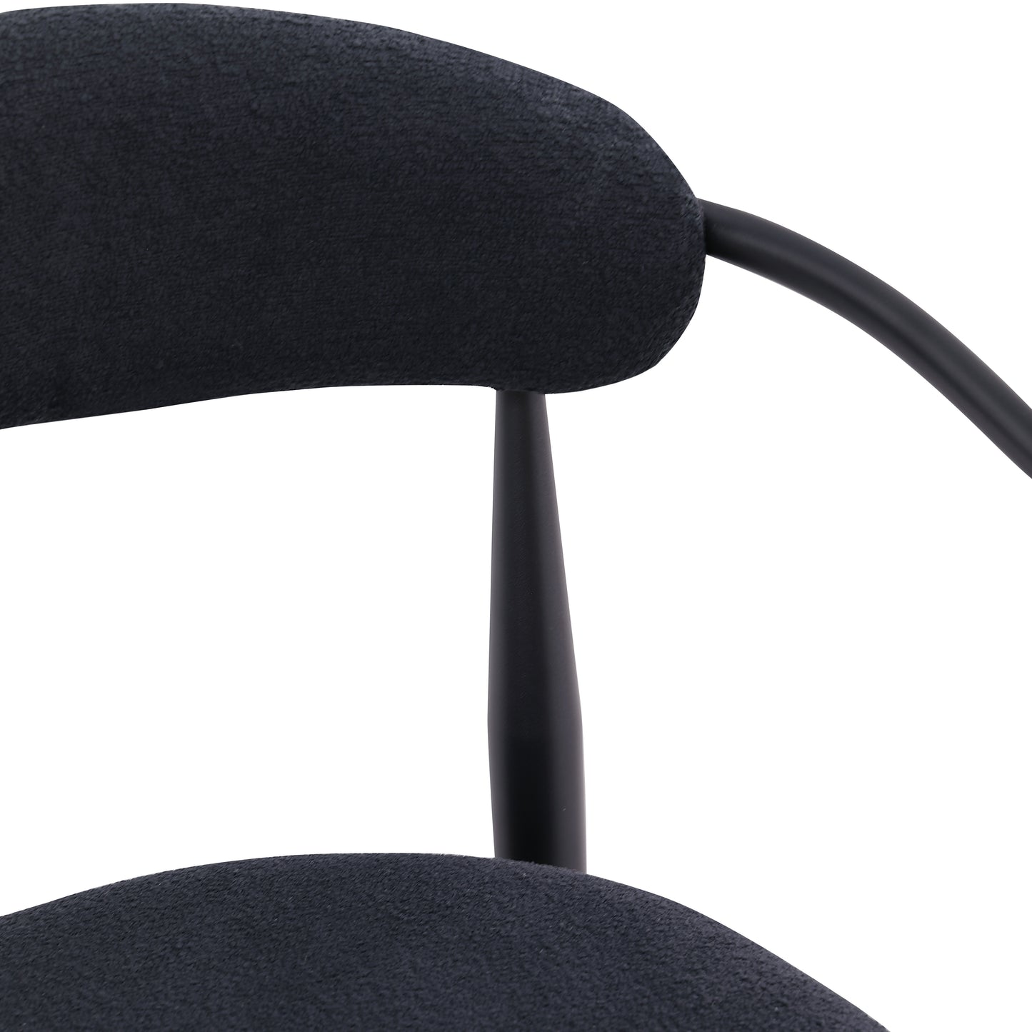Black upholstered midcentury modern chair detail with curved back and tapered leg