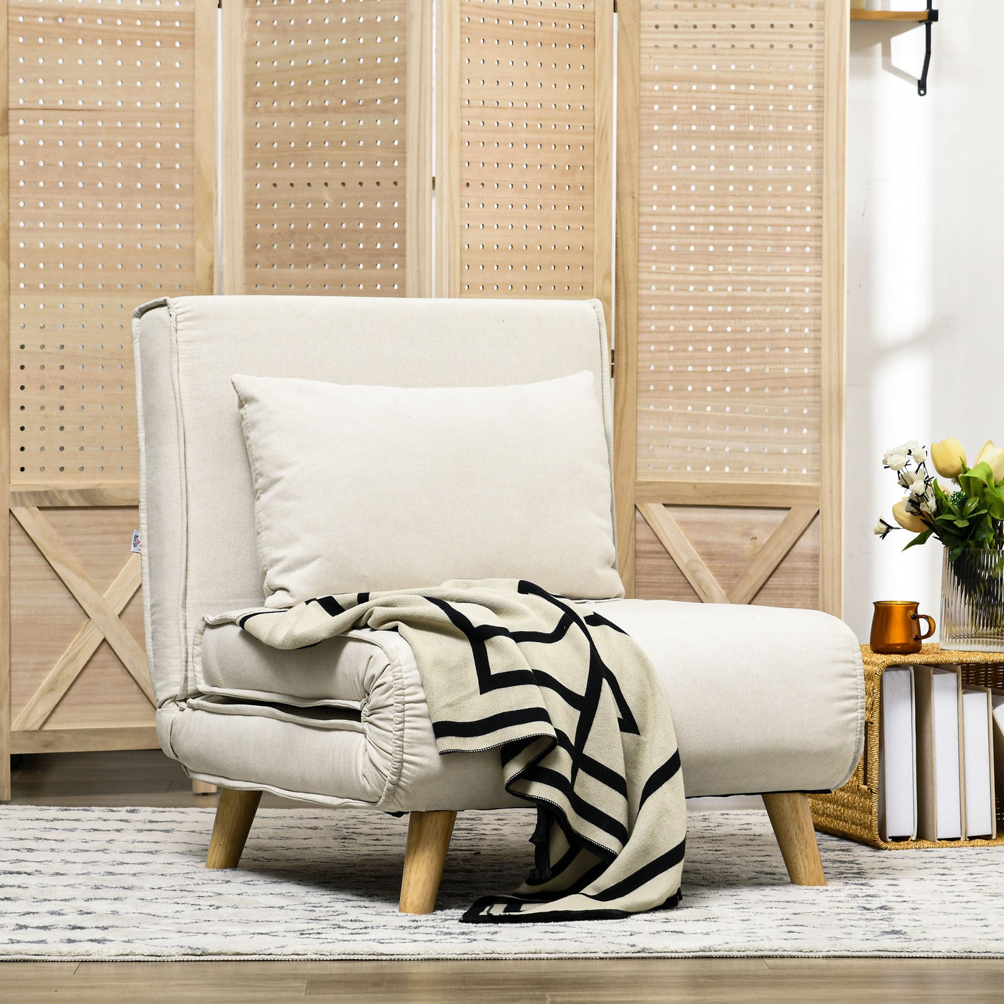 Cream accent chair with black and beige throw blanket accent pillow and wooden legs