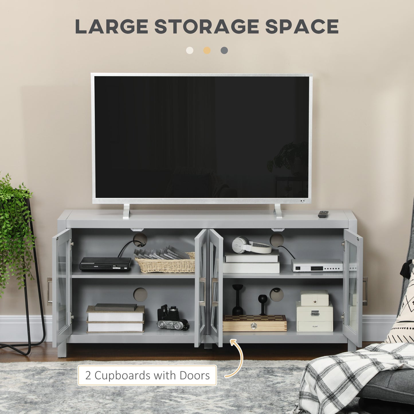 Grey media console with two cabinets and a shelf holding electronics and decorative items