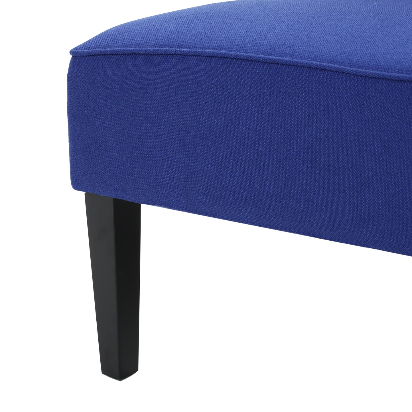 Deep blue upholstered bench with tapered black legs fabric texture visible
