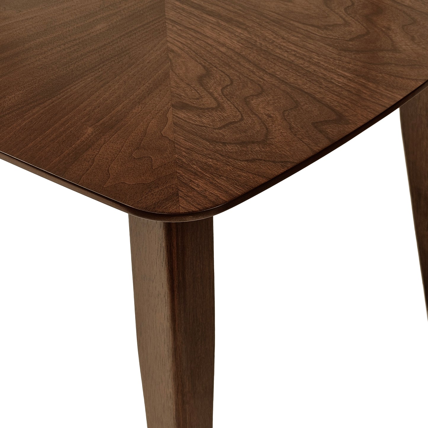 Closeup of a dark walnut wood table with a geometric pattern and tapered legs