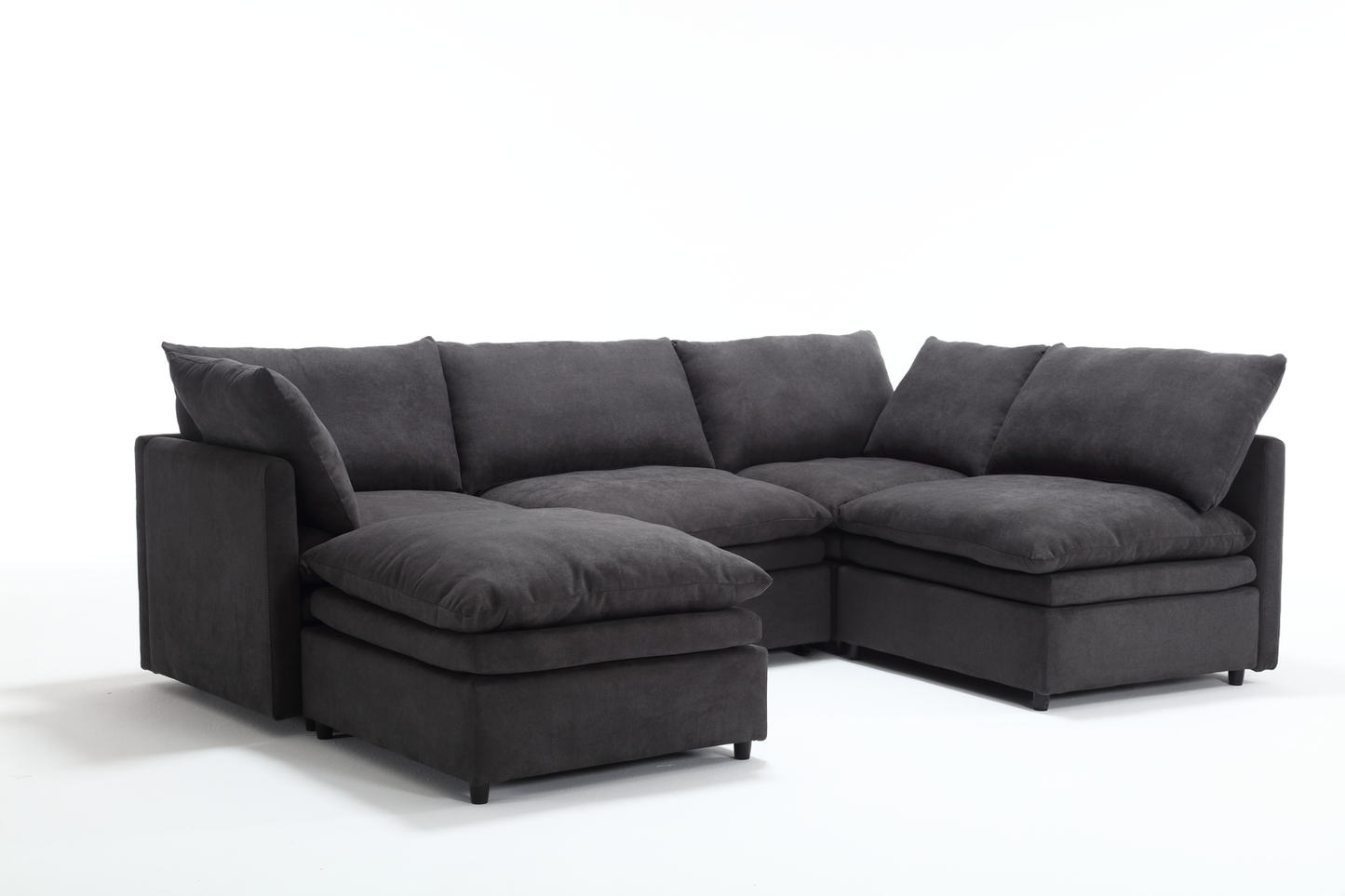 Deep charcoal sectional sofa with plush cushions and a chaise lounge for ultimate comfort