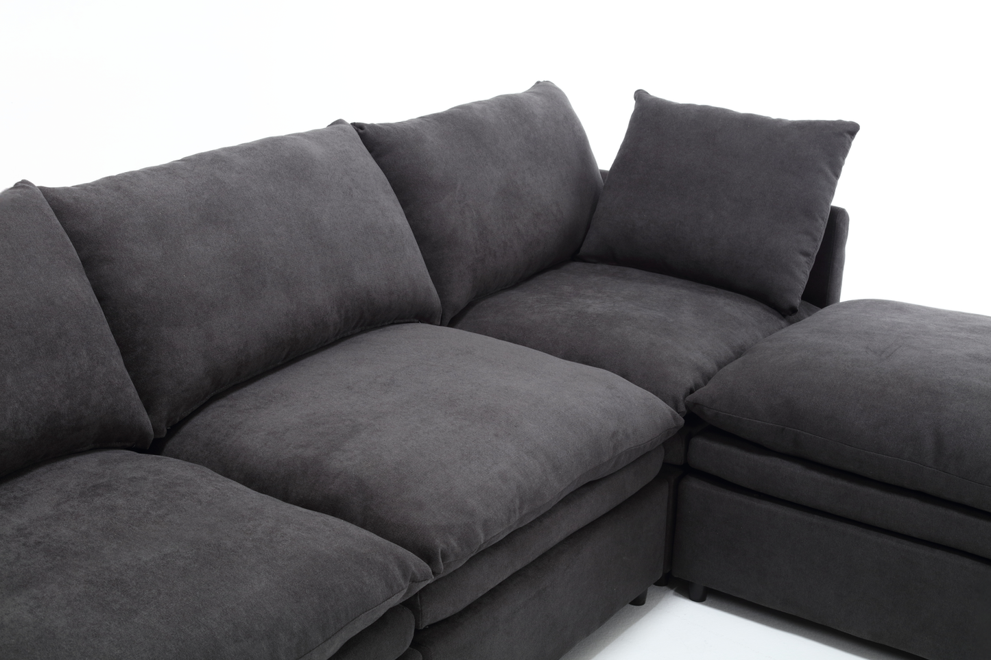 Dark gray modular sectional sofa with plush cushions and a chaise